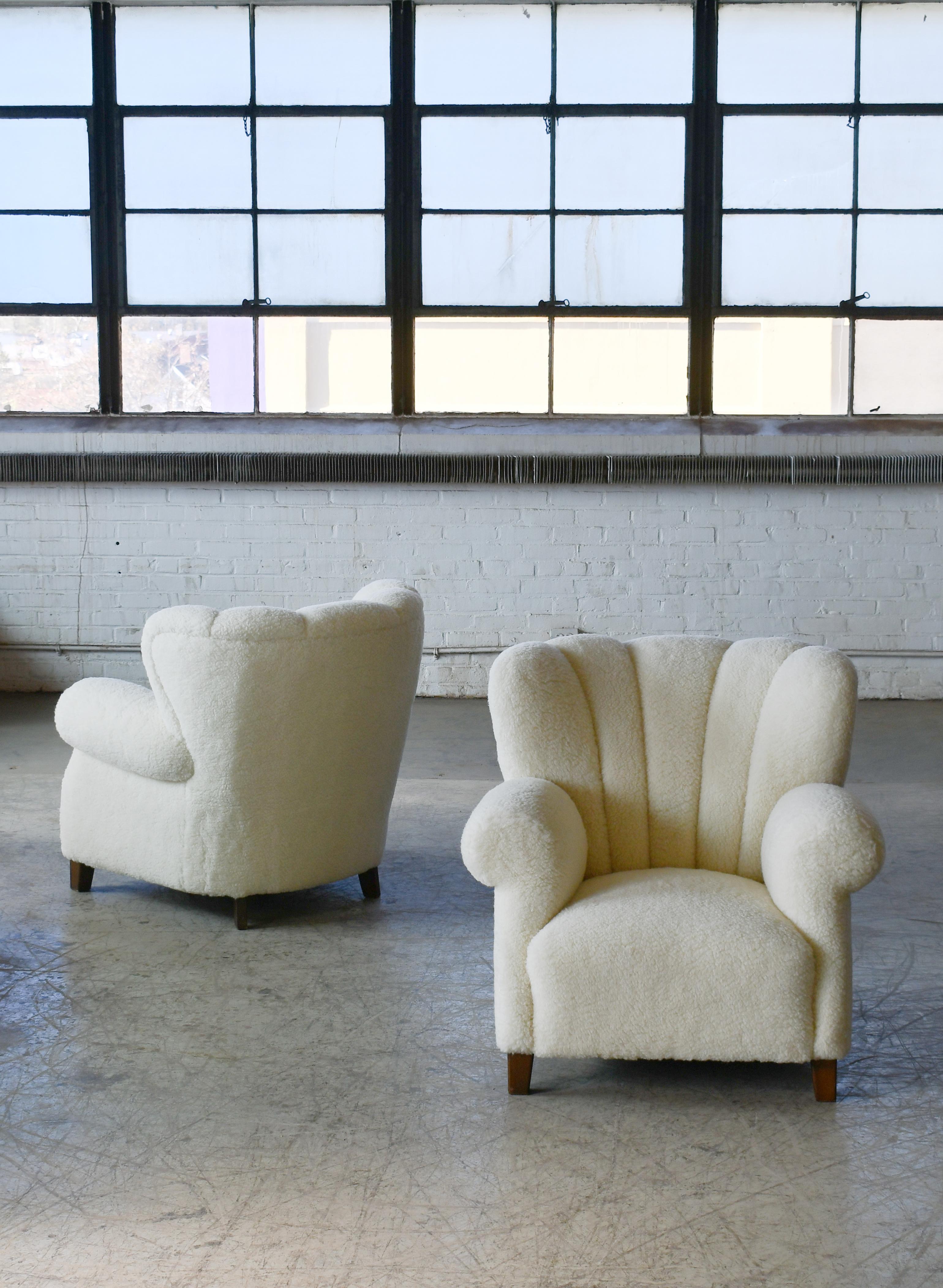 Pair of sublime large scale pair of model 1518 lounge club chairs made by Fritz Hansen in the late 1930s or early 1940s. Superbly comfortable with their dramatically low and wide proportions have charming and very strong presence to anchor any room.