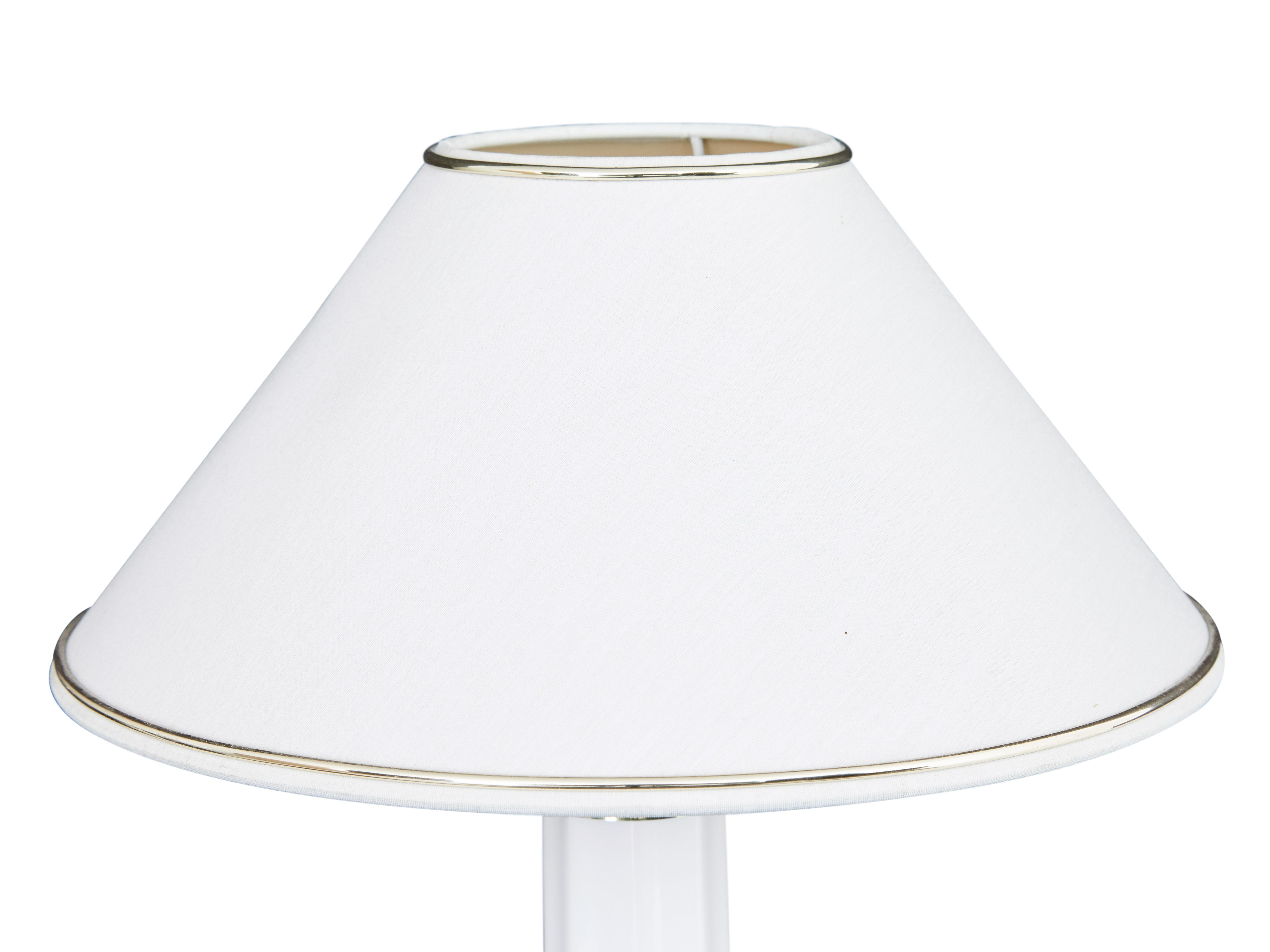 Pair of Danish Heiberg white ceramic table lamps by Soholm.

Good quality pair of table lamps of the well known 'Heiberg' model, made by Soholm of Denmark. Fluted column and base with decorative brass collars, complete with original shades with