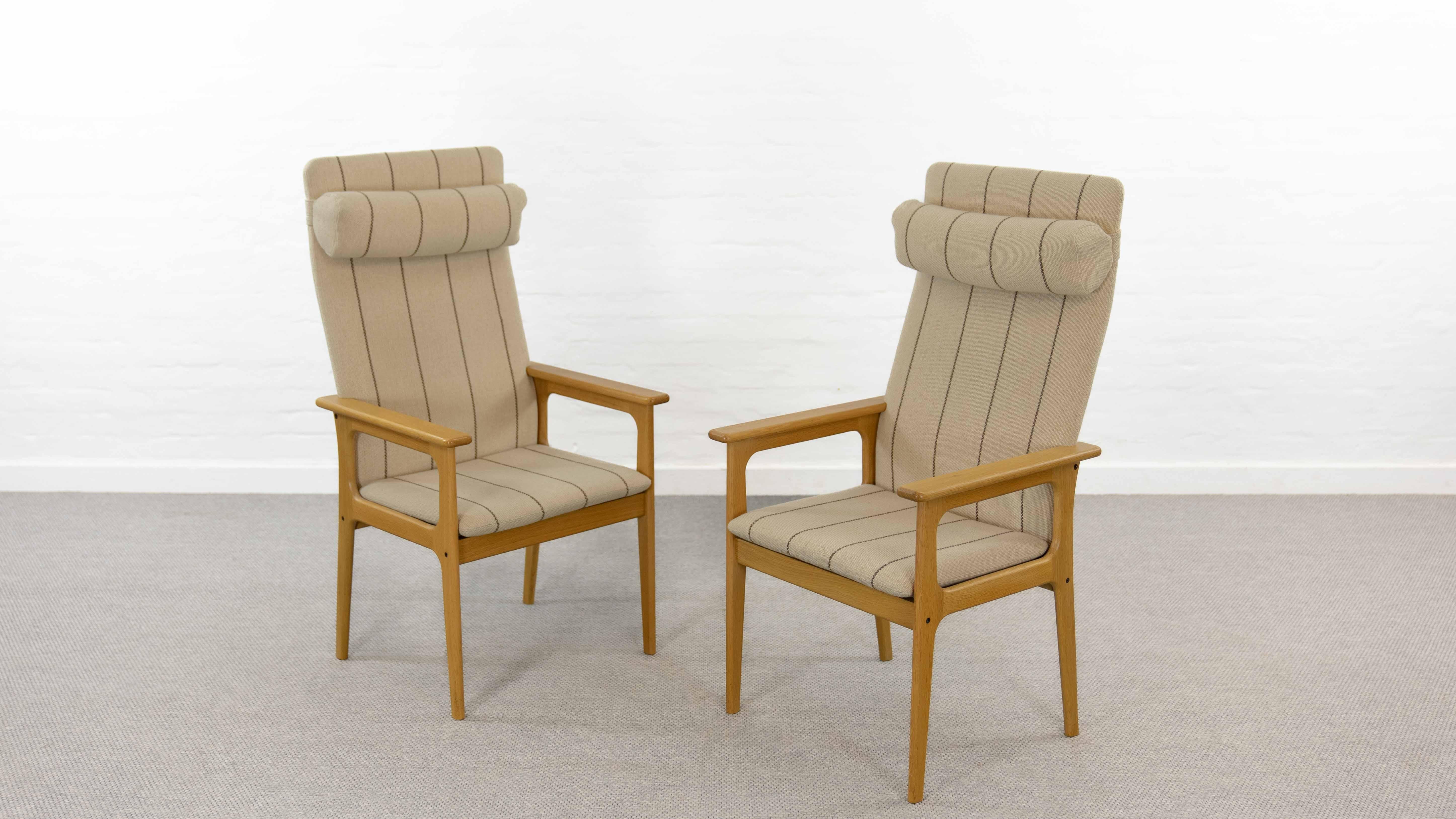 Set of two midcentury Highback Chairs in by Domus Danica, Denmark. Design is attributed to Erik Buck.  Executed in oakwood, upholstered in its original striped woolfabrics. Adjustable Head/neck cushion. Very good used condition. Labeled underneath