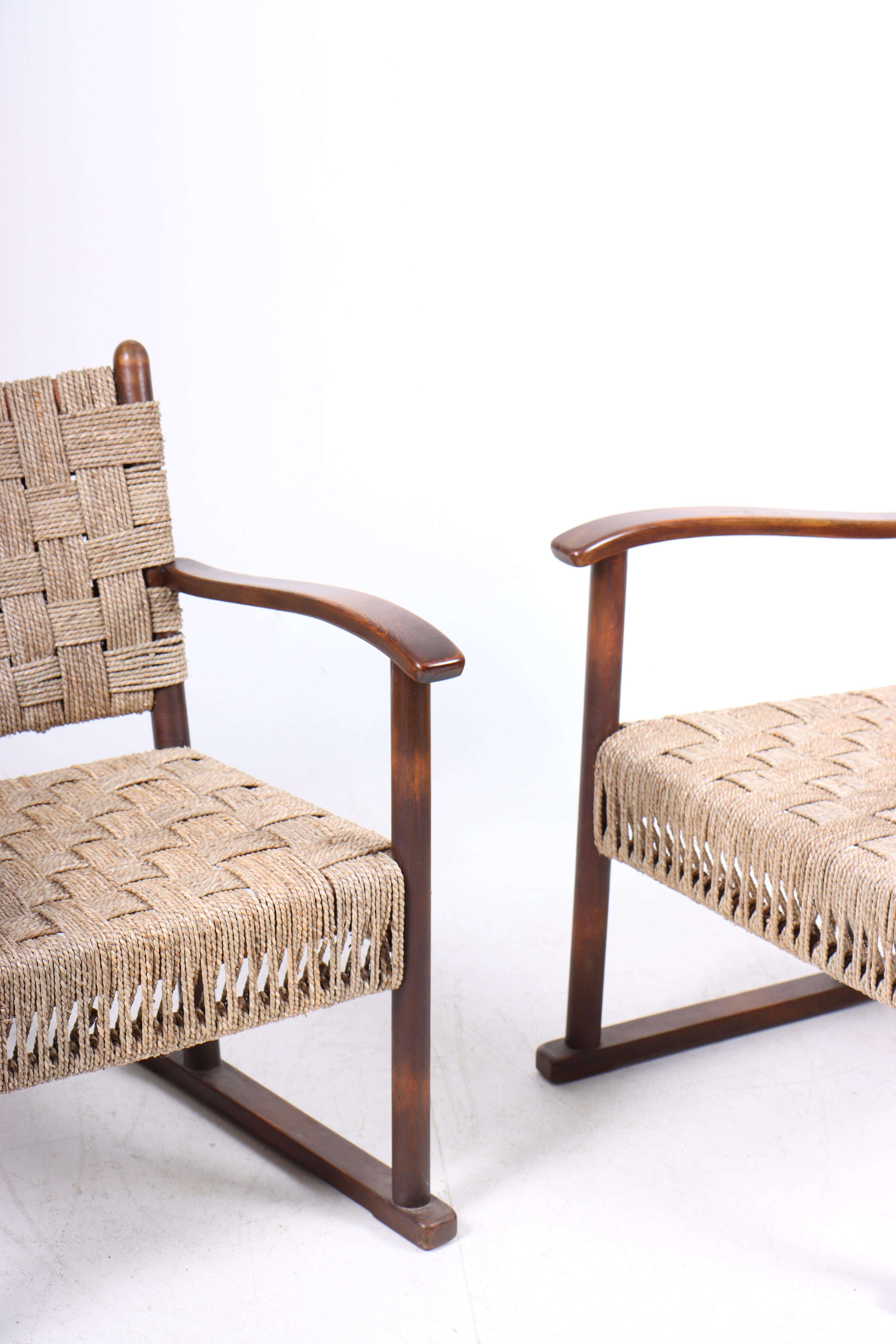 Pair of lounge chairs in beech and seagrass designed and made by Danish cabinetmaker Fritz Hansen in the 1940s.