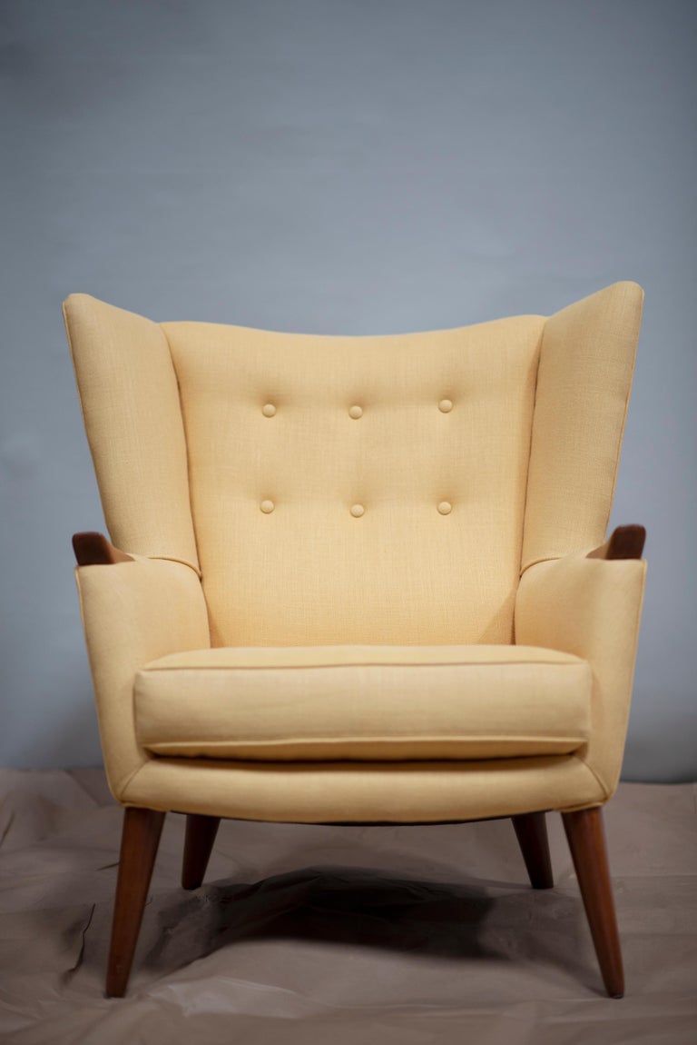 A beautifully upholstered brilliant yellow wool fabric pair of Danish lounge chairs. Artist is unknown but originating from the 20th century in Denmark. Date of manufacture is set in the 1960s. The upholstery is in perfect condition with no visible