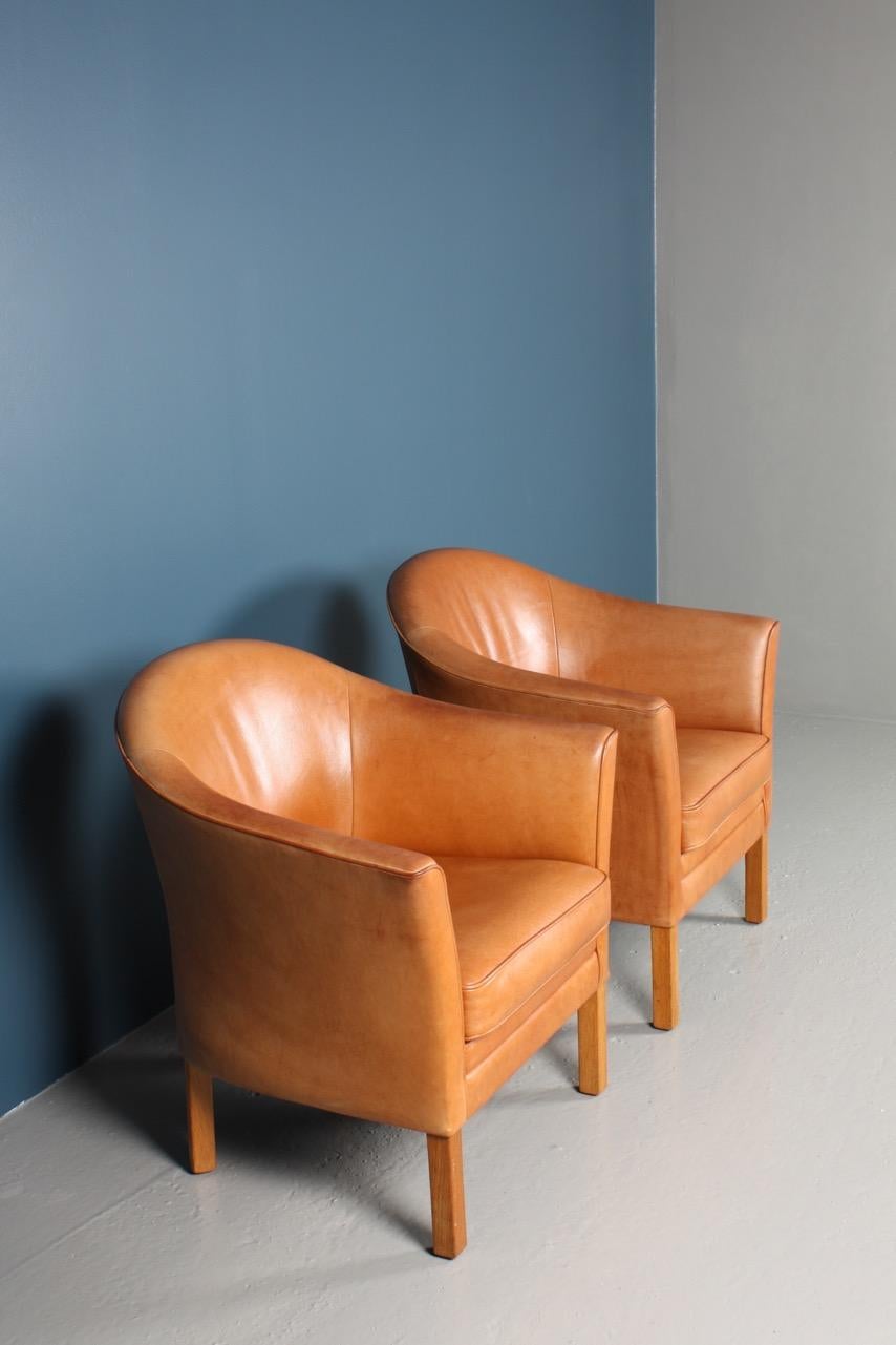 Pair of great looking and very comfortable lounge chairs in beautifully patinated leather. Designed by Danish architect Lars Kalmar and made by Morgens Hansen in the 1970s. Great original condition.