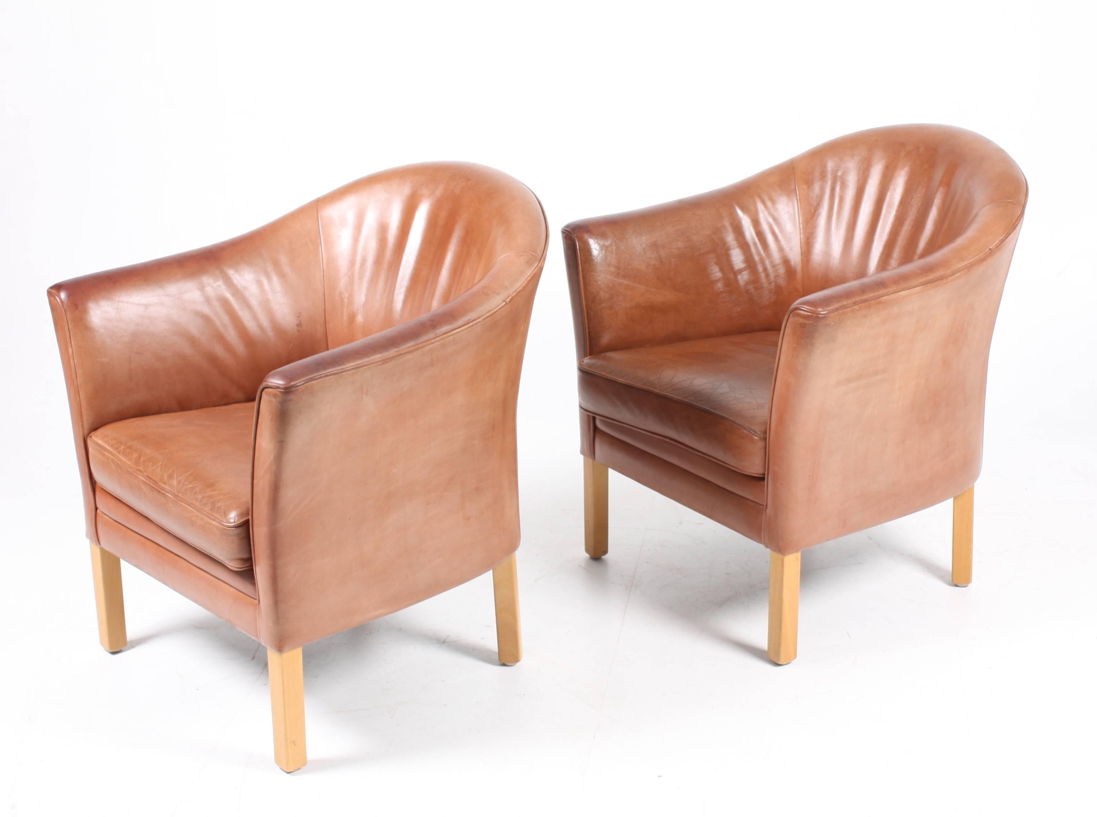Pair of great looking and very comfortable lounge chairs in beautifully patinated leather designed by Danish architect Morgens Hansen in the 1970s. Great original condition.