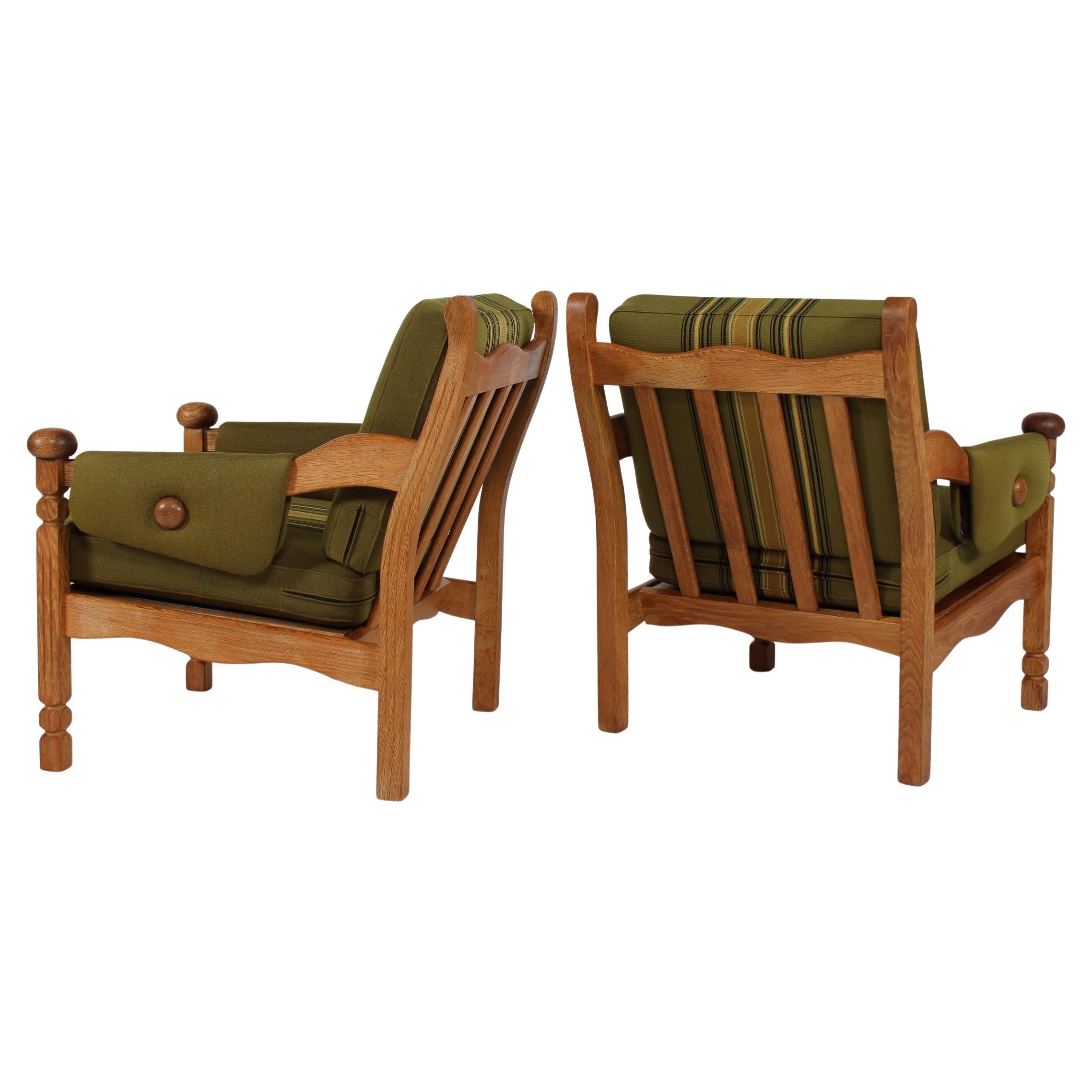 Pair of Danish Lounge Chairs of Solid Oak in Henning Kjærnulf style 1970s