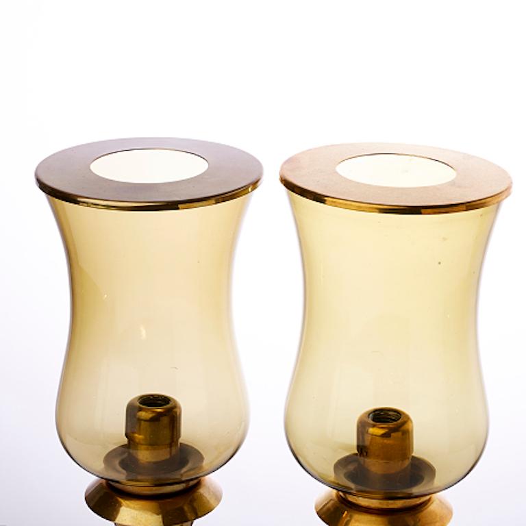 These two Danish table lanterns from the 1970's have brass frames with gold-toned lids.
 