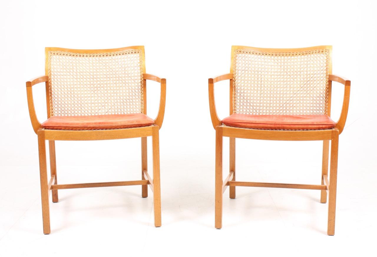 Pair of armchairs in mahogany, cane and patinated leather. Designed by Ditte & Adrian Heath for Søren Horn cabinetmakers. Made in Denmark in the 1960s. Great original condition.
