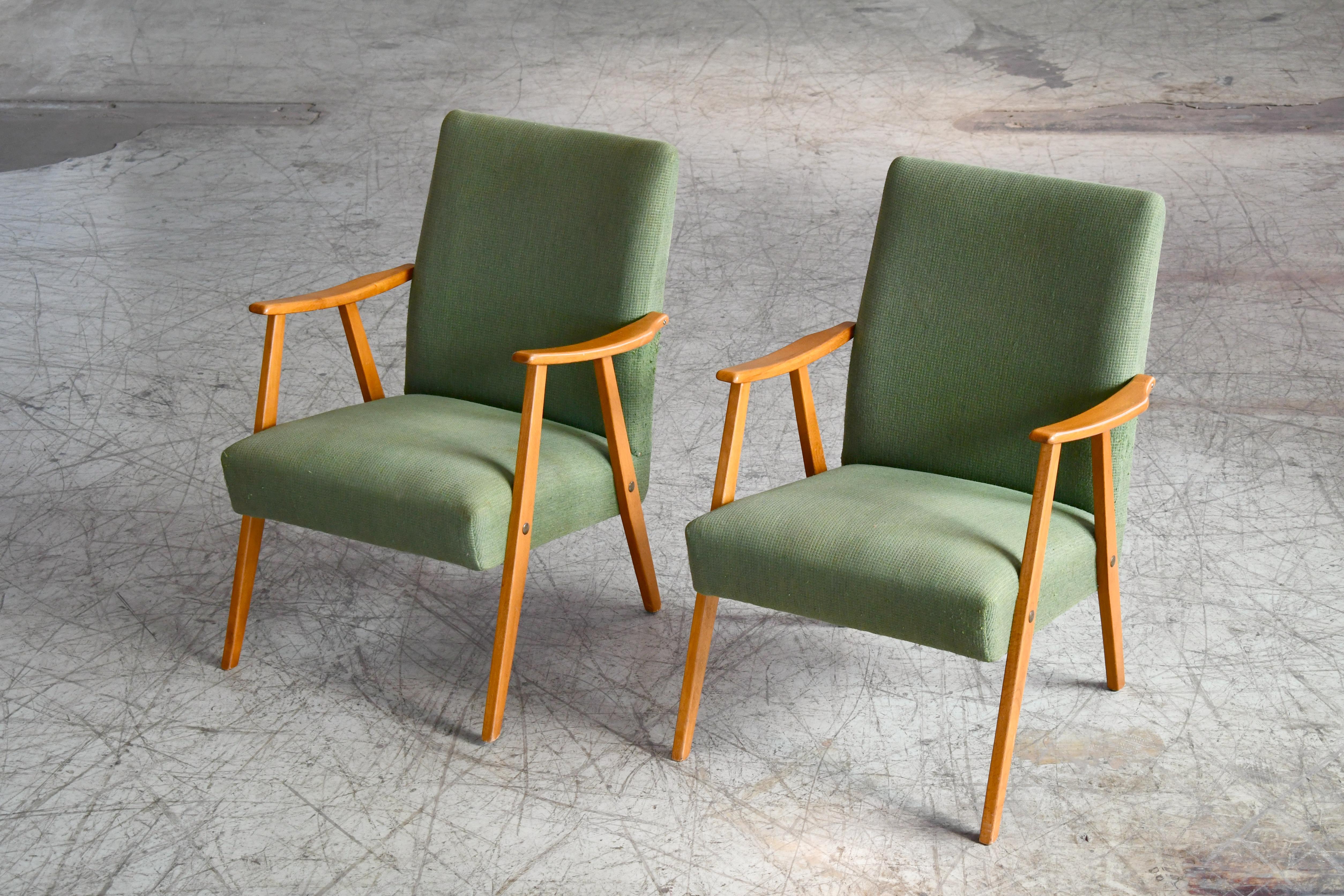 Really nice pair of 1960s easy chairs very similar in style to some of Arne Vodder's typical designs with the slight curvature to the armrests in solid elm wood and the slightly higher backrest. Nice light versatile chairs and overall in very good