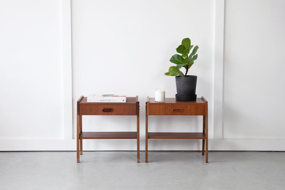 A beautiful pair of bedside tables by Ulferts Mobler of Sweden. Dating back to the 1950's these single drawer teak nightstands showcase simplicity and style.