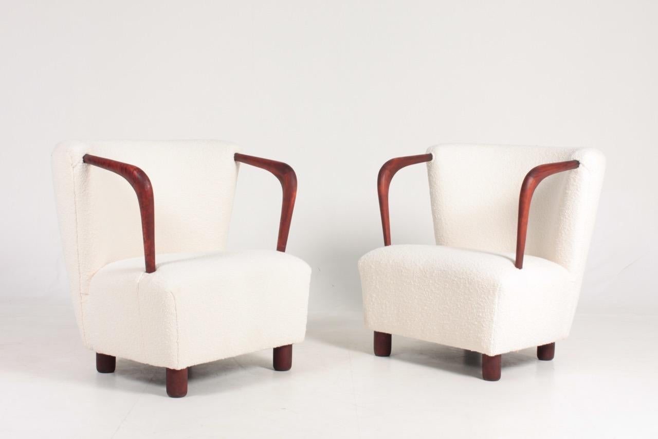 Pair of lounge chairs in upholstered in bouclé. Designed and made in 1940s. Great condition.