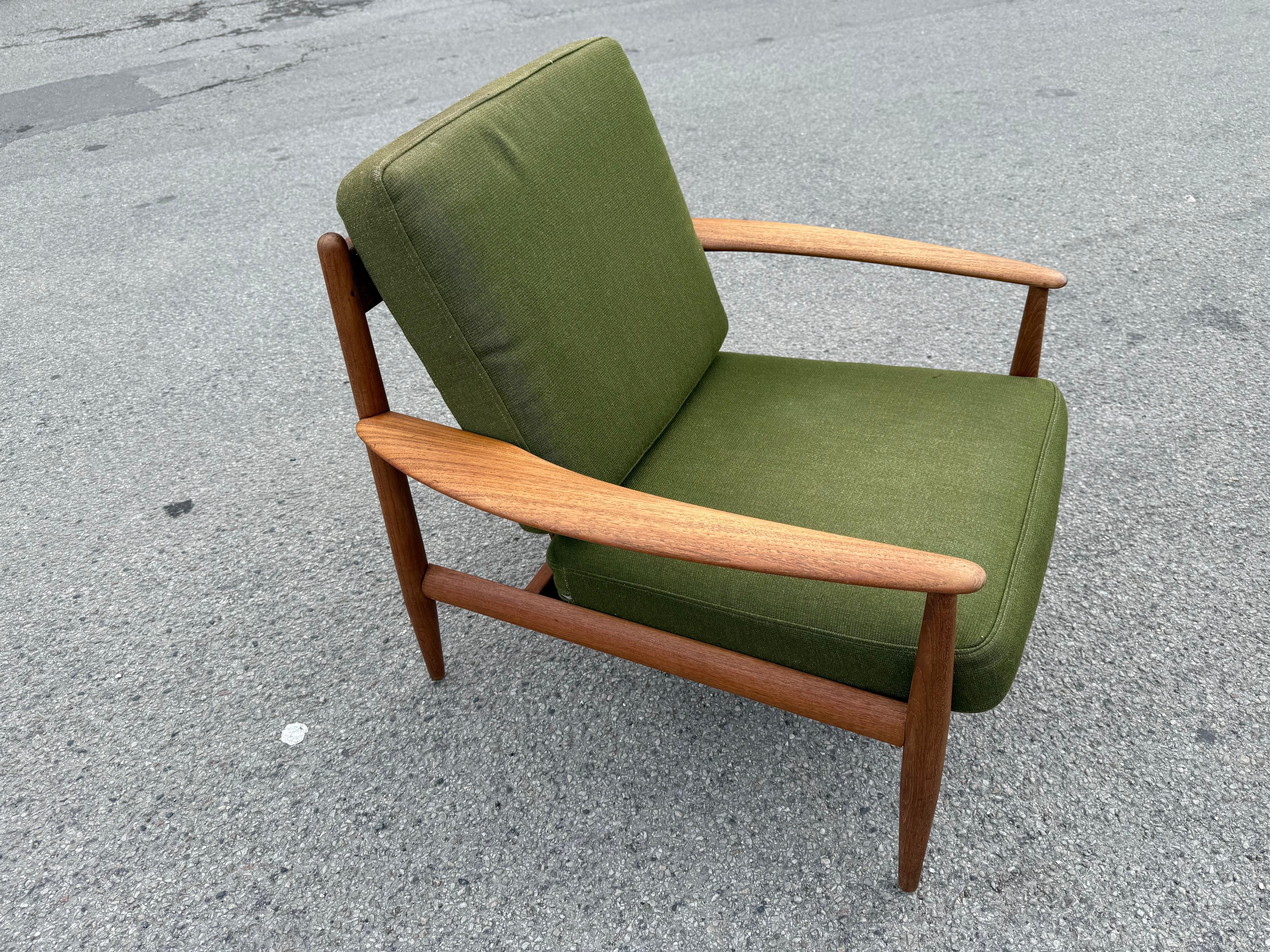 Set of lounge chairs by one of the few Danish female mid-century furniture in the refined teak woodwork. A beautiful pair of chairs with organic shapes and clean lines giving them a stunning profile. With its refined sculpted armrests and intricate