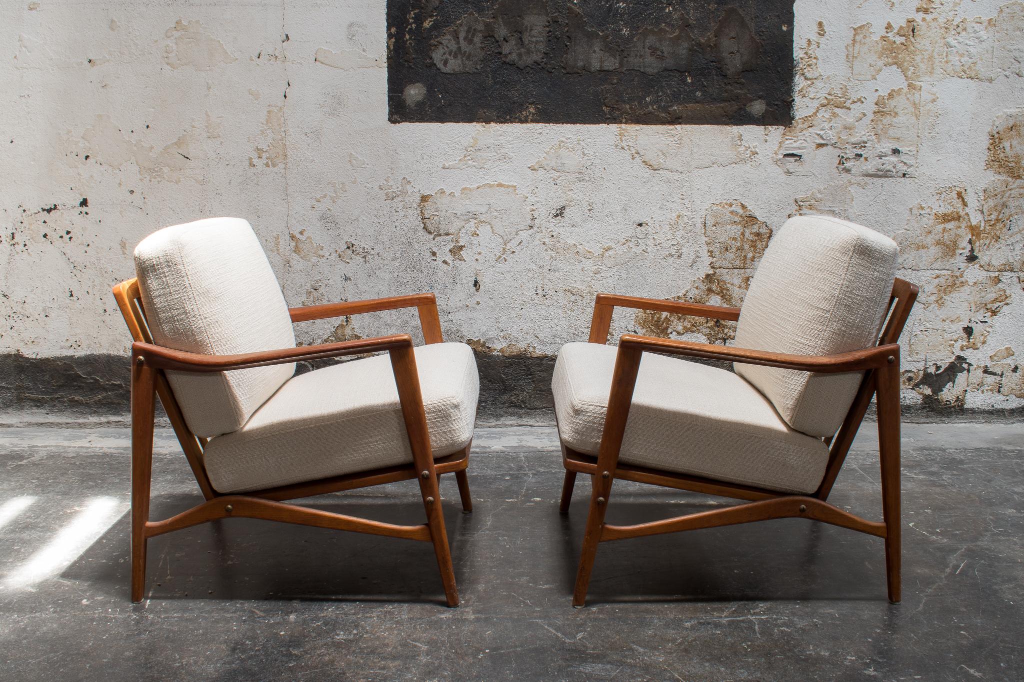 Pair of vintage Mid-Century Modern teak armchairs with newly reupholstered cushions. Made by OPE, sleek Swedish design ensures that these chairs work in a variety of settings and styles! Versatile, beautiful, and ready to be yours.

-28