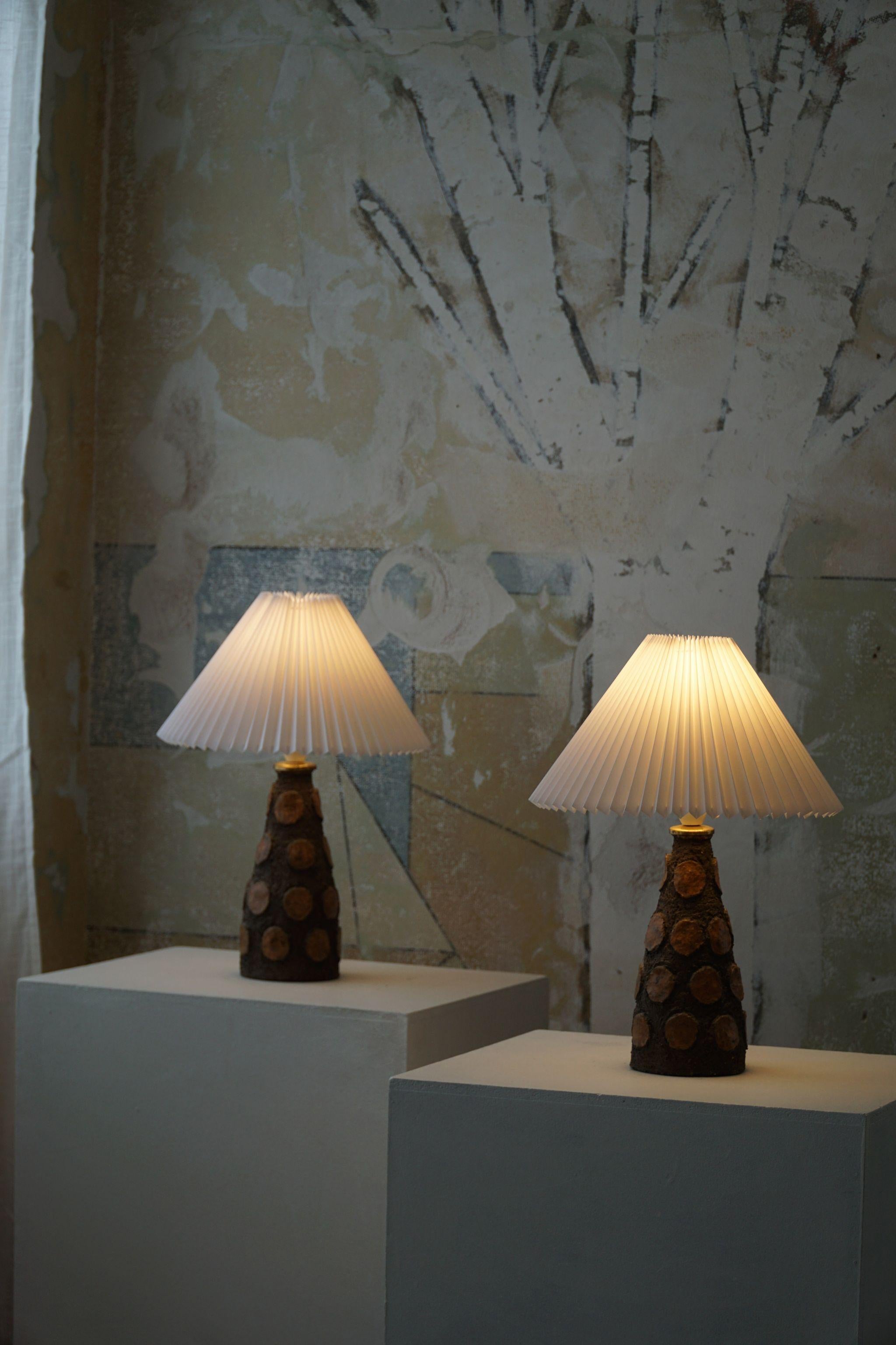 Pair of handmade table lamps, made by a unknown Danish artist, stamped R N. A fine experimental craftsmanship of the 1970s in great vintage condition. Made in various brown & orange colors.

A beautiful vintage lamp well suited for the Modern