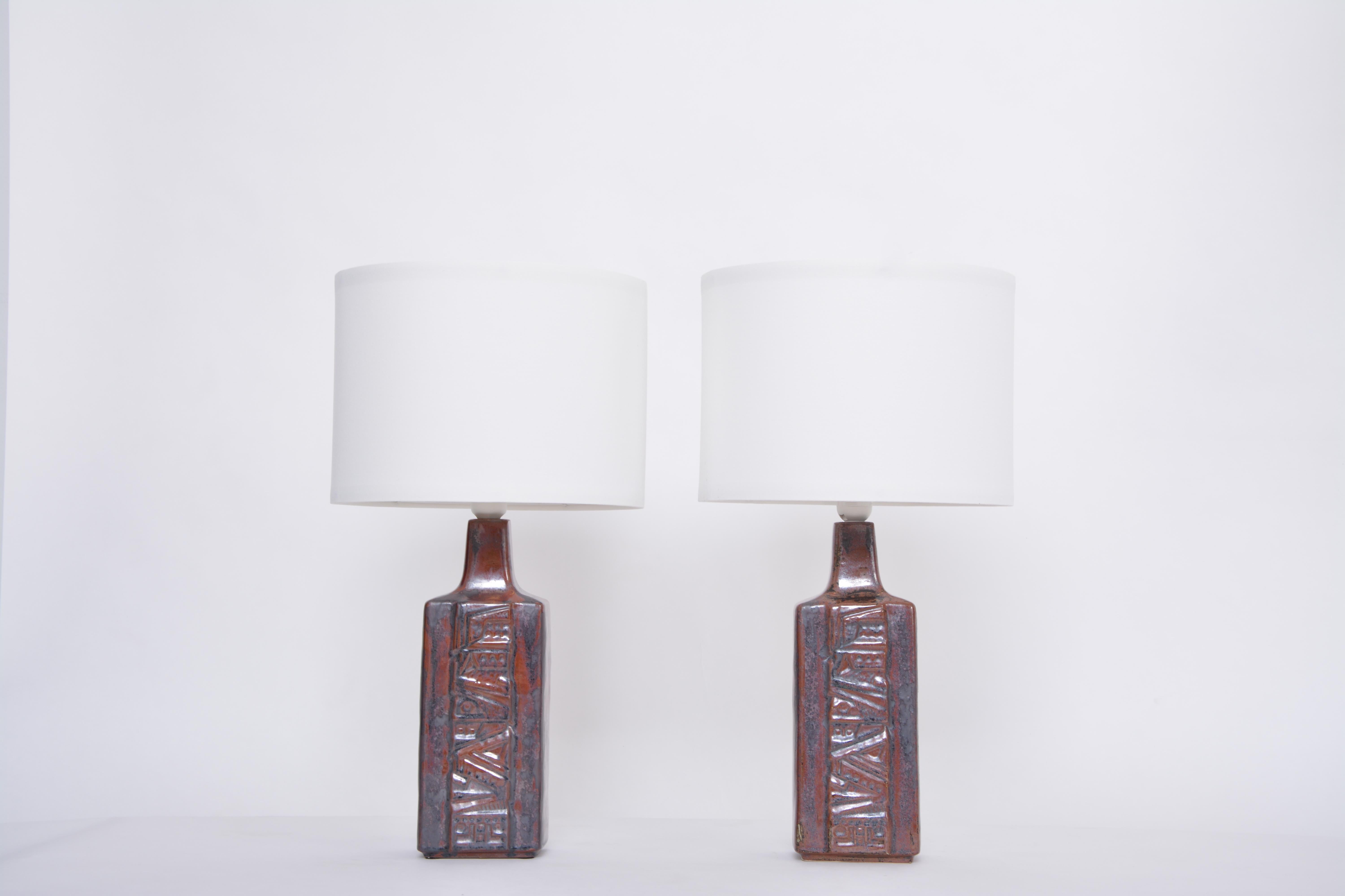 Pair of Danish Mid-Century Modern Ceramic Table Lamps by Desiree Stentoj
These lamps were produced by Danish company Desiree Stentoj probably in the 1960s. The lamps are made of glazed stoneware. The bases feature an abstract geographic pattern and