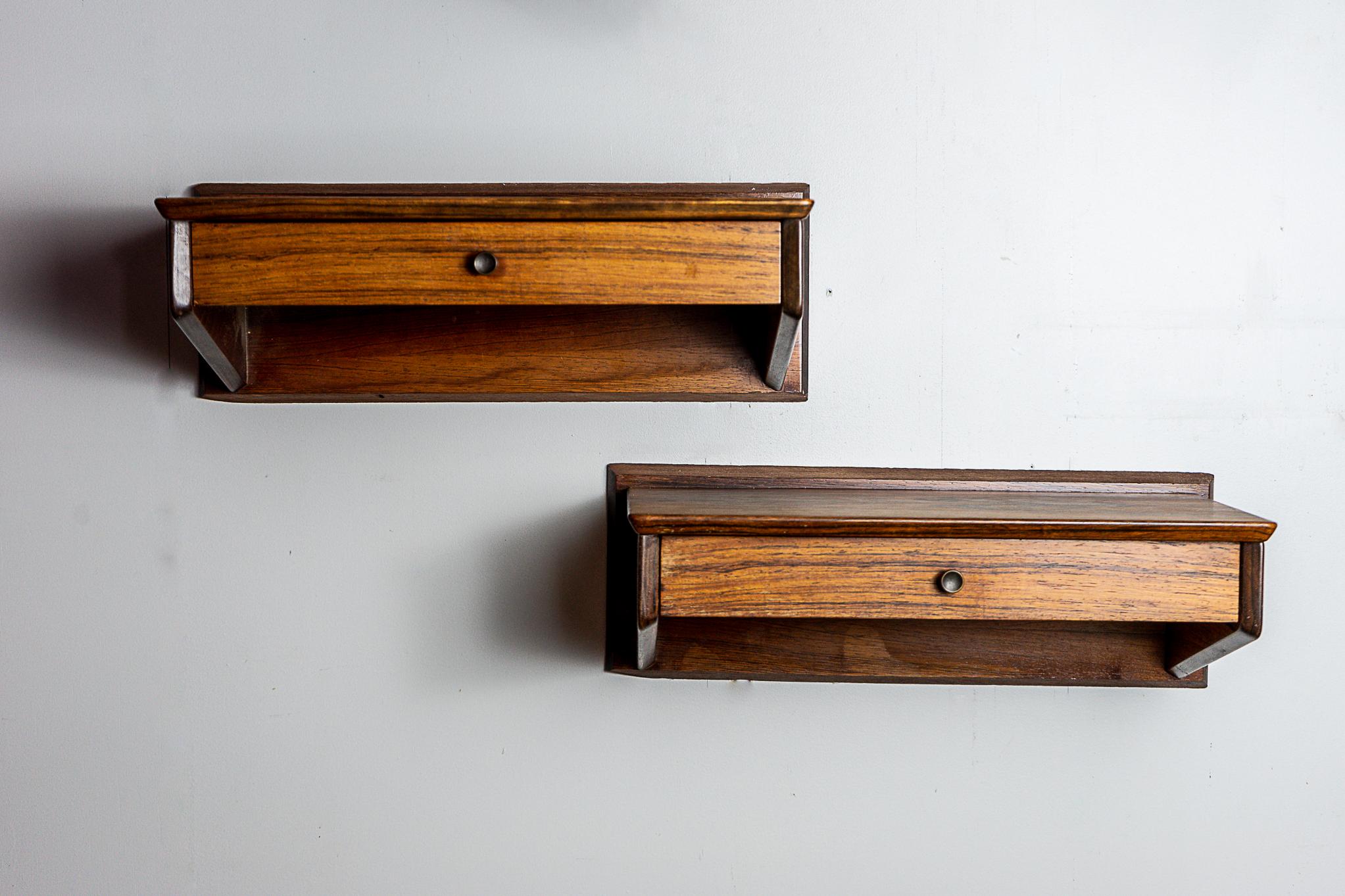 Rosewood Danish bedsides, circa 1960's. Beautifully veneered wall mount nightstands for sleek small spaces. Slim profile, dovetailed drawers, pure elegance! 

Unrestored item with option to purchase in restored condition for an additional $150 USD.