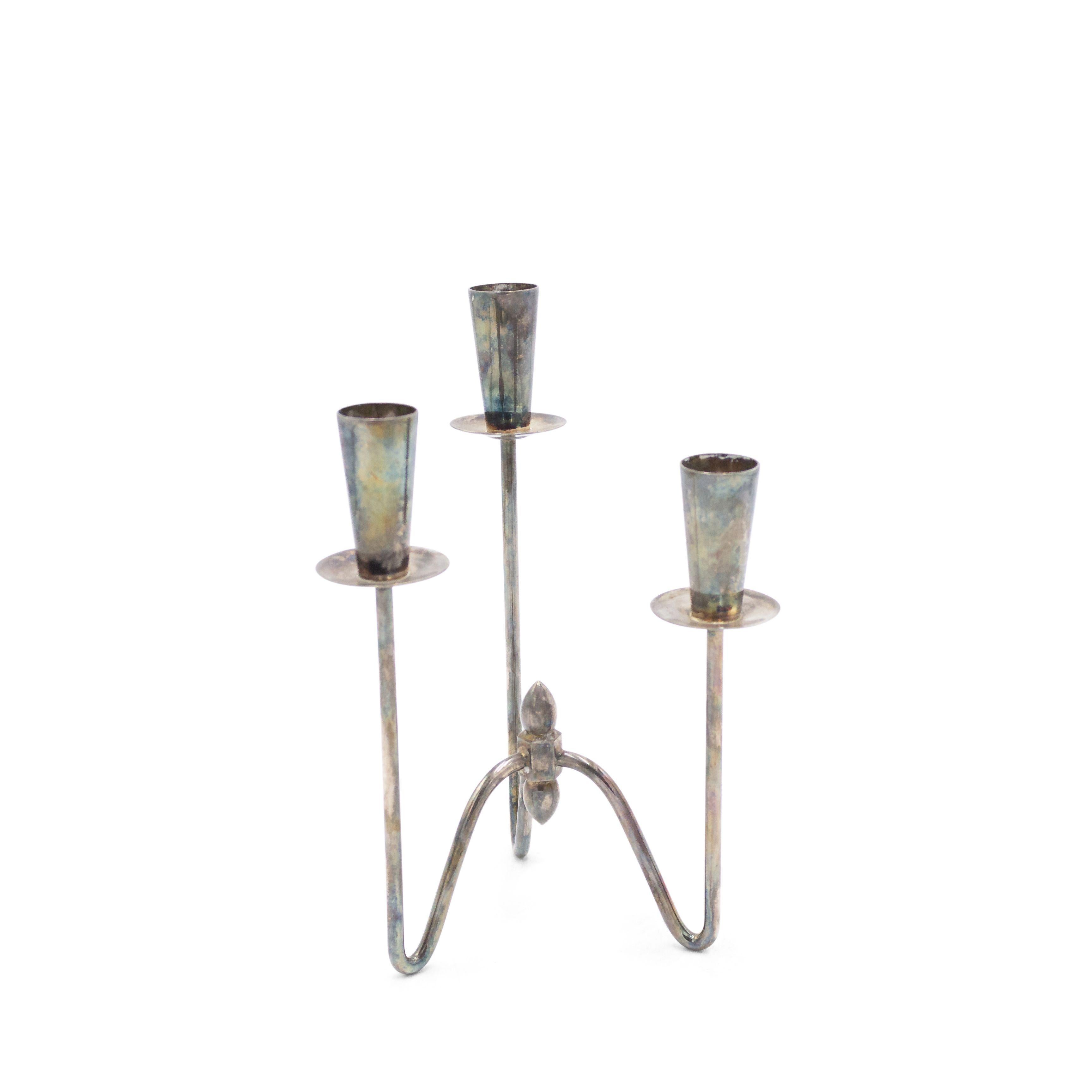 Pair of Danish mid-century silver plate small candelabras with 3 separate arms connected with a stretcher and a centered finial (priced as pair).
     