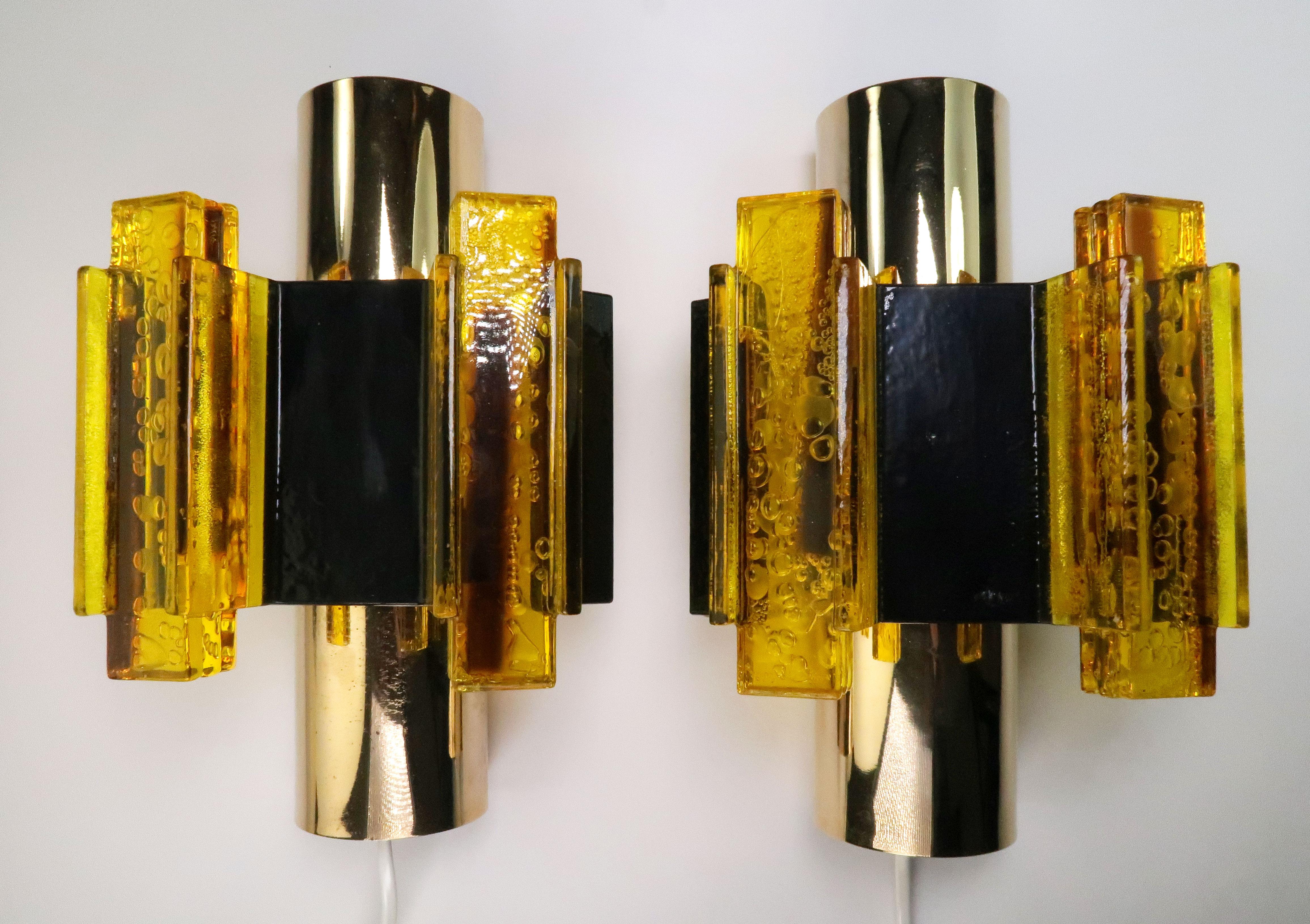 Set of two handmade Danish midcentury Space Age modernist wall lights by Danish designer and flight engineer, Claus Bolby. Manufactured by CeBo Industri in Jutland in the 1970s. Yellow rectangular acrylic resin sticks creating sculptural decoration