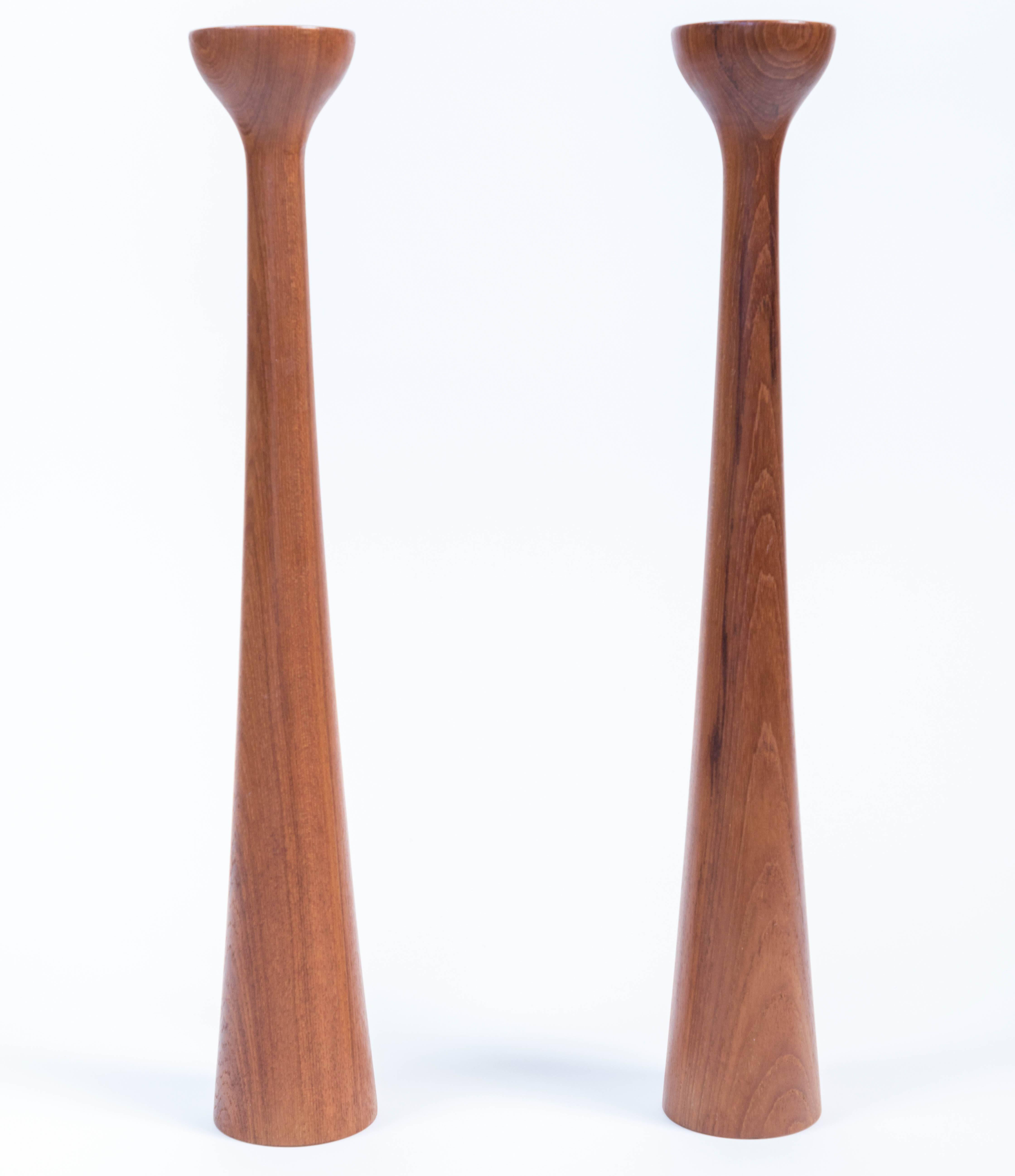 Pair of midcentury tall teak candlesticks from H + F Denmark.