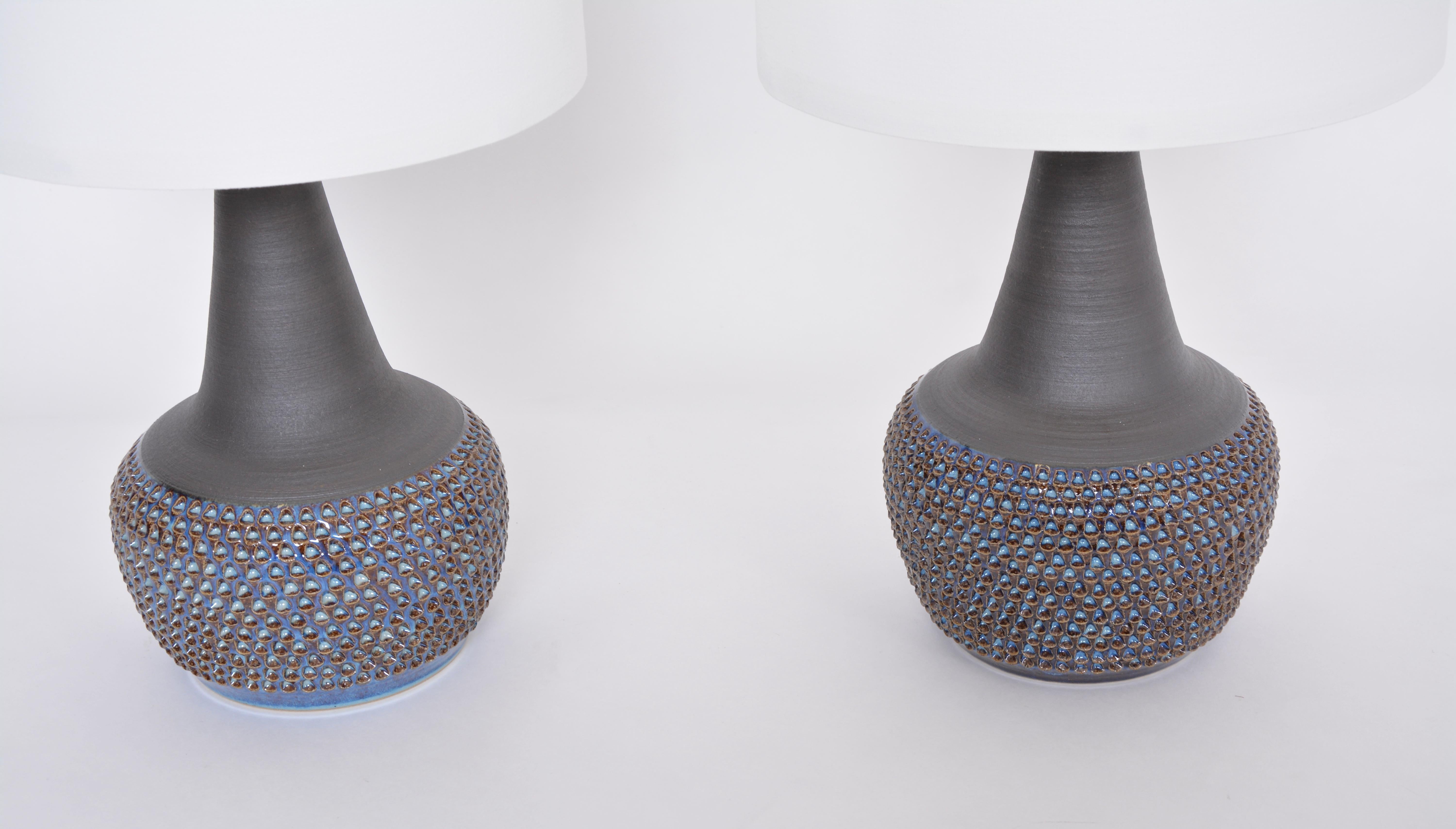 Pair of Handmade Danish midcentury ceramic lamps Model 3048 by Einar Johansen for Soholm
Stunning table lamps handmade of stoneware with ceramic glazing in different tones of blue. Pattern made of circular incisions to the base of the lamps.