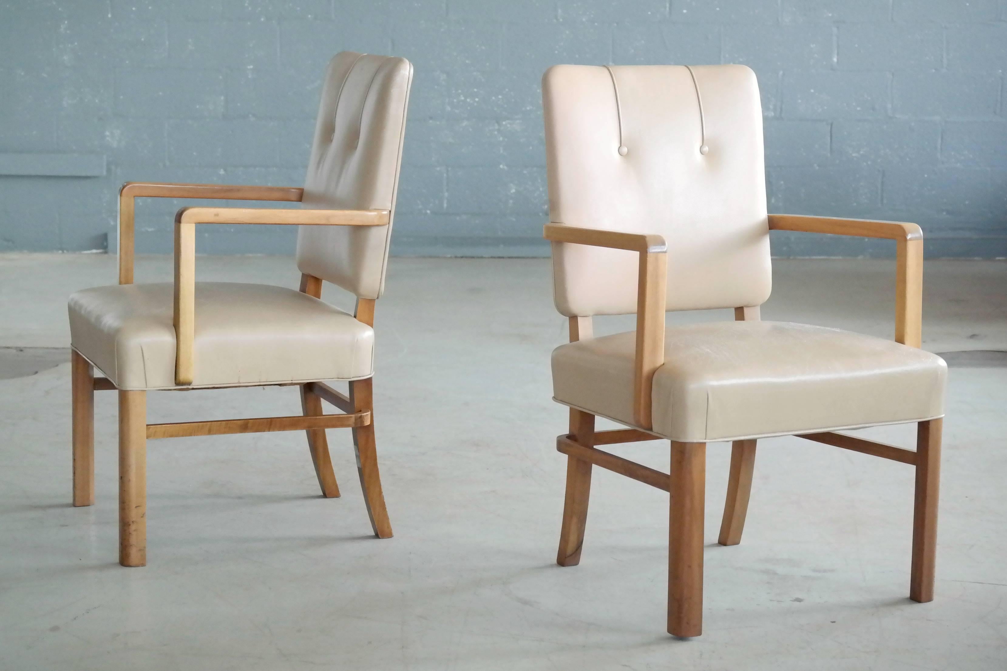 Extremely high quality and very stylish executive desk chairs made in Denmark by unknown furniture maker circa 1960. Made from stained beech wood that has faded somewhat over the years. Covered in a supple tufted leather in light tan. Leather shows