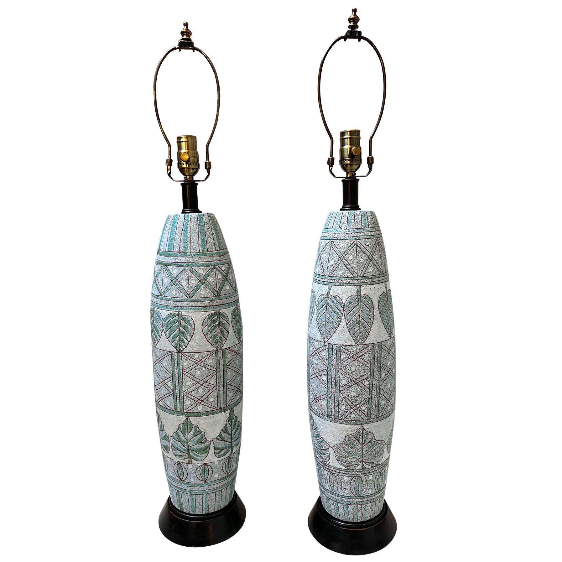 Pair of circa 1960's ceramic table lamps with painted decoration.

Measurements:
Height of body: 22.5