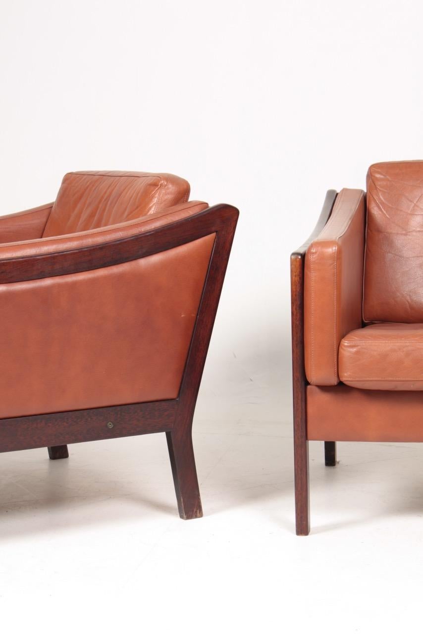 Pair of lounge chairs in patinated leather designed and made in Denmark. Great original condition.