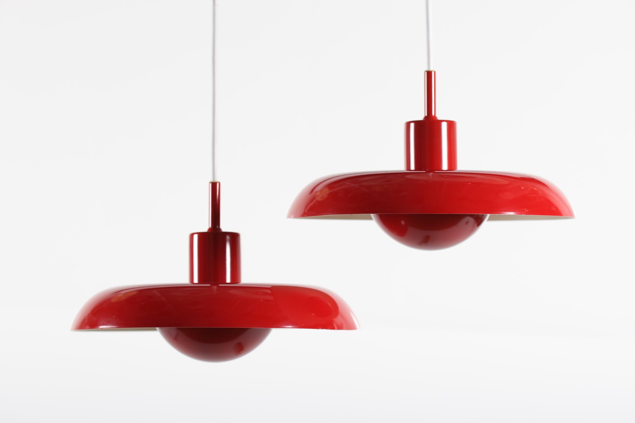 Here is a rare pair of Danish midcentury Piet Hein lamps model RA in the small version.
The pendant lights are made of metal with red and white lacquer by the Danish lamp manufacturer Lyfa in Copenhagen, circa 1960s.

They remain with full