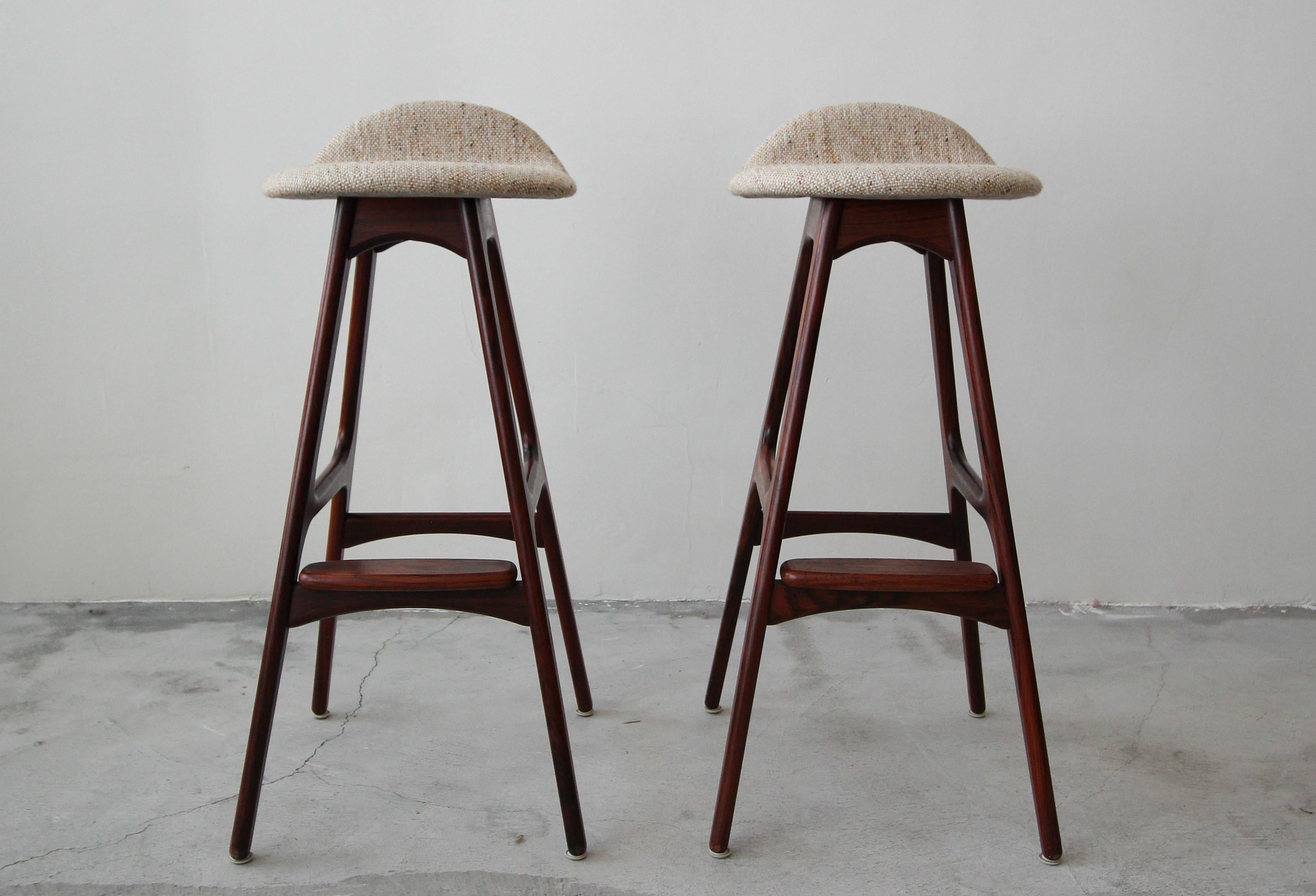 Flawless and all original pair of Danish rosewood bar stools by Erik Buch. Rosewood is in mint condition as is the original tweed upholstery. These stools literally look like they sat some where untouched, for 50+ years. Rosewood grain is stunning.