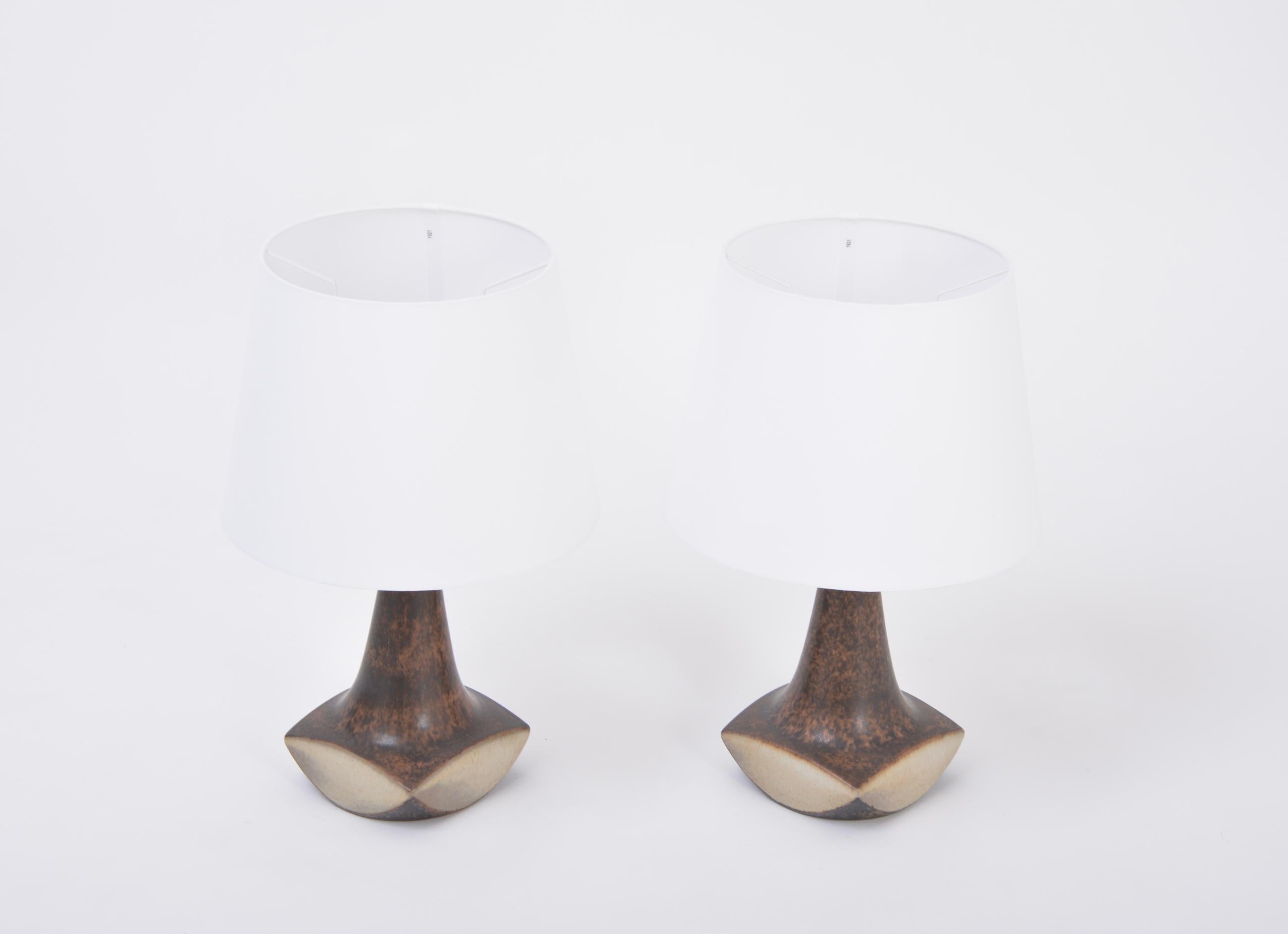 Pair of Danish midcentury table lamps by Marianne Starck for Michael Andersen 
This pair of table lamps was designed by famous Danish artist Marianne Starck in the 1960s and produced by Michael Andersen & Søn.
Beautiful sculpturally shaped base