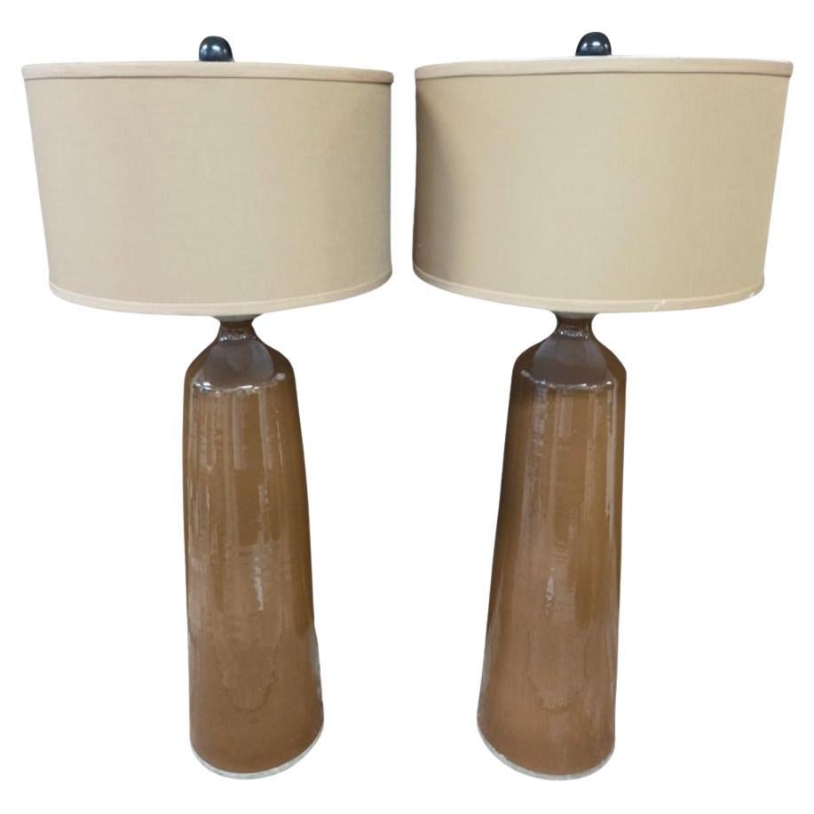 Beautiful pair of 1970s Danish stoneware lamps. Complete with custom-made lamp shades. These excellent pieces make a bold and somewhat sculptural statement. The warm tones and patina of the surface glaze is inviting and Rich. A beautiful pair of