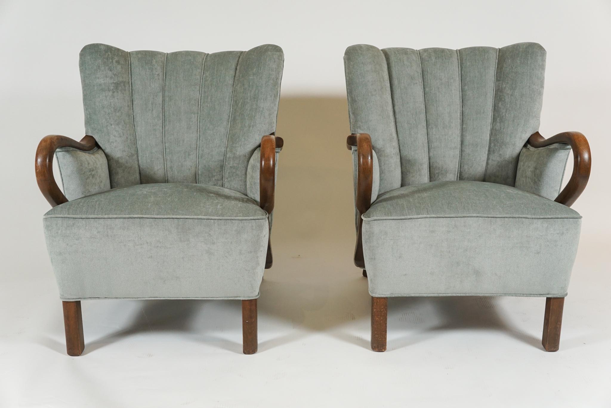 Pair of Danish modern, channel-back armchairs with exaggerated open arms, in oak, newly upholstered in pale grey-blue velveteen, solidly built from 1940s, very comfortable and stylish would fit in lounge, living room, library or den.