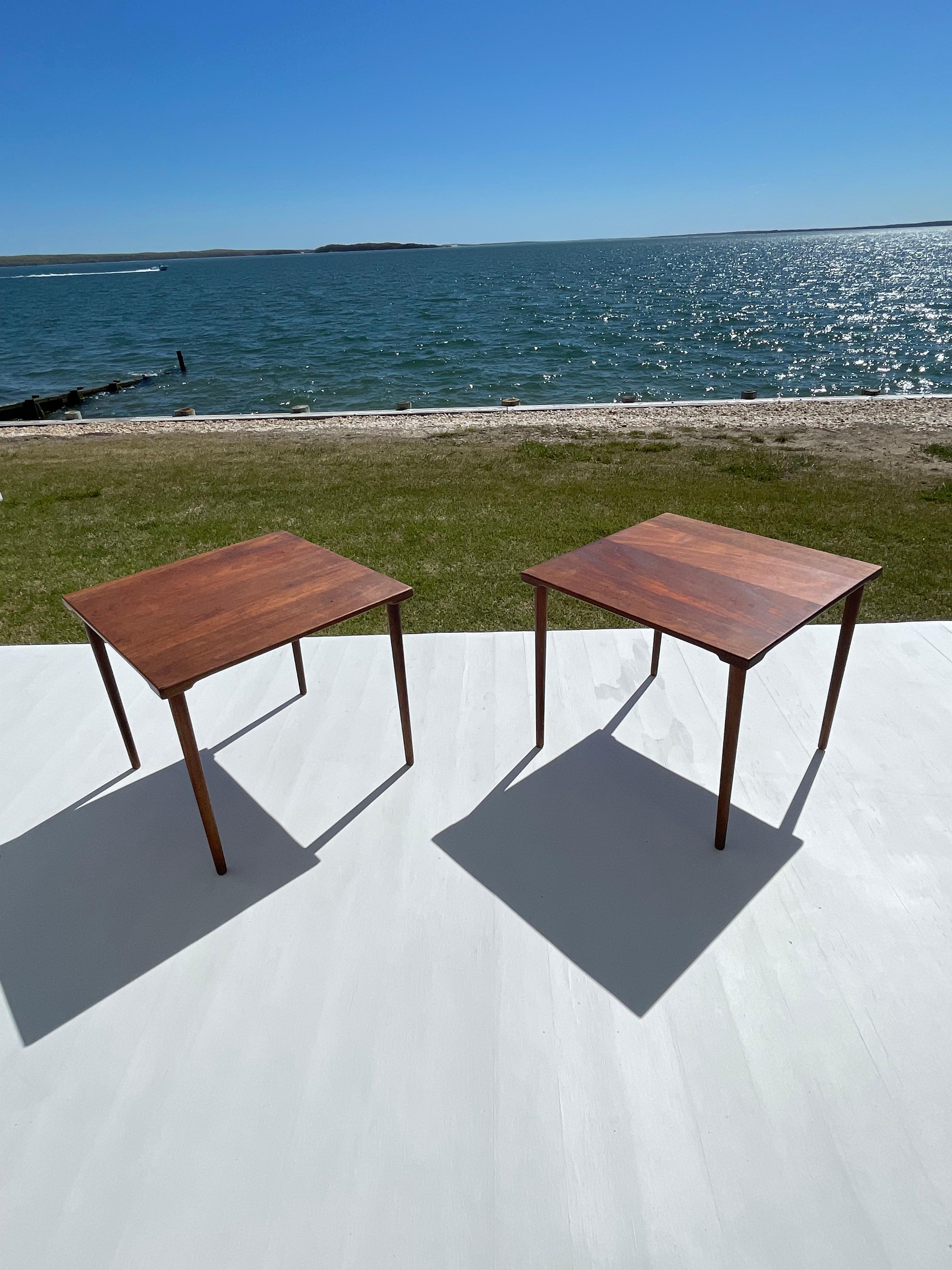 Minimalist and beautiful solid teak occasional tables can be stacked or used as end tables or night stands. The tables were designed by Peter Hvidt for John Stuart Inc. and made in Denmark in the 1960s . This sleek Danish modern design features a