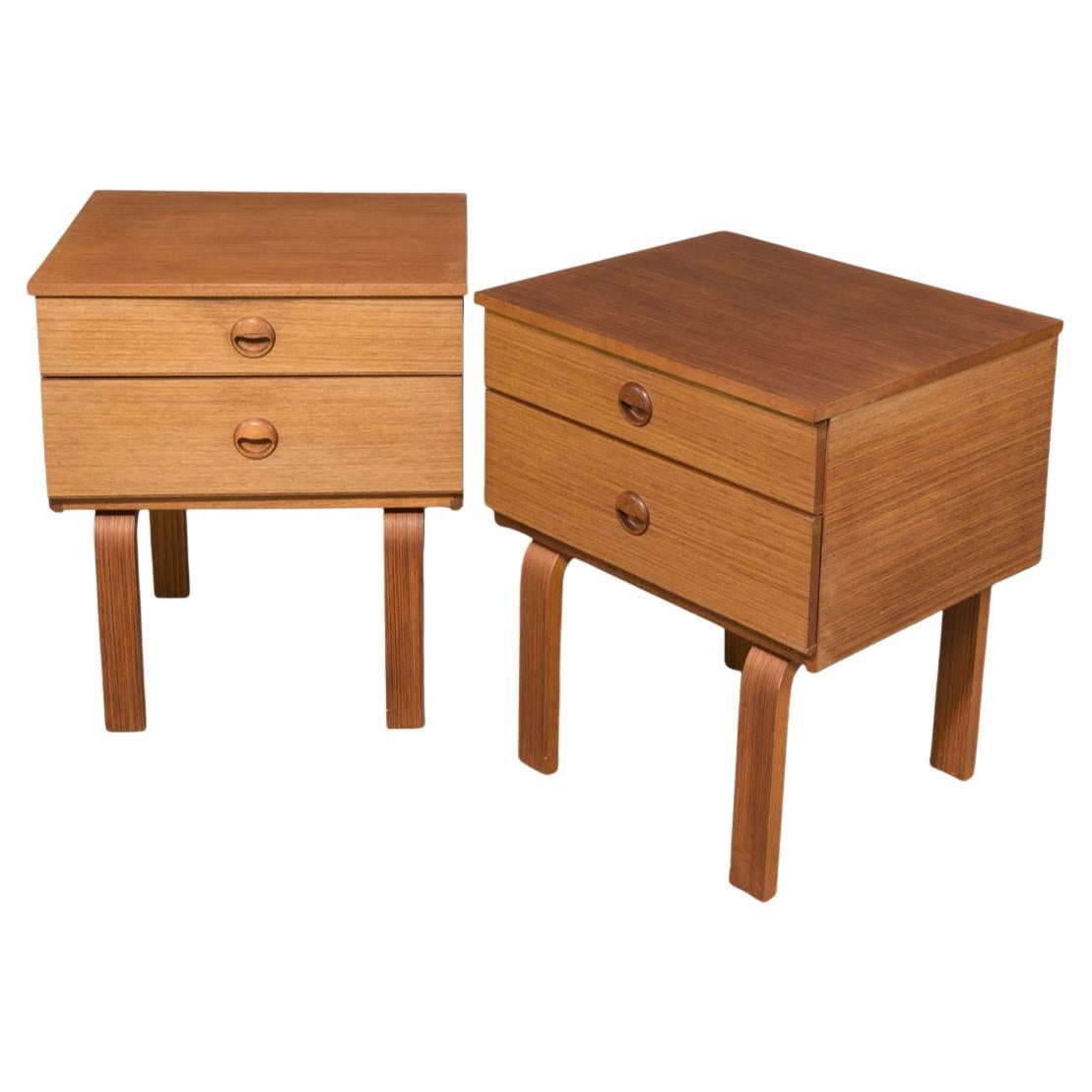Pair of Danish modern 2 drawer teak nightstands with carved handles. Great designed Scandinavian bedside tables with 2 drawers that sit on curved flat legs. Clean inside and out. Ready for use. Located in Brooklyn NYC.

Sold as a Pair of (2)