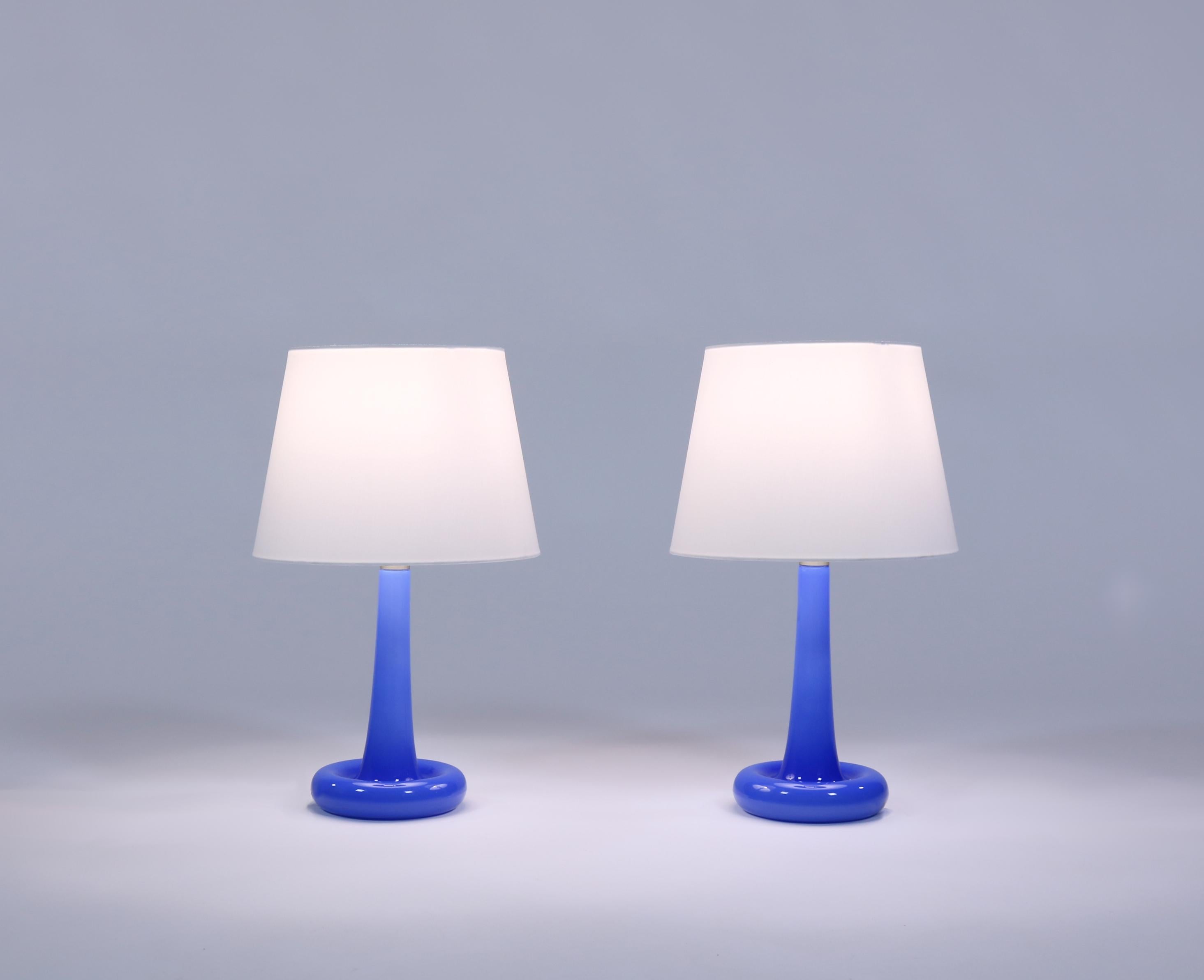 Beautiful blue table lamps made in 1975 at Holmegaard Glassworks, Copenhagen. The design is by renown glass artist Michael Bang and each lamp was mouth blown. The shape resembles a flower and the model was called 