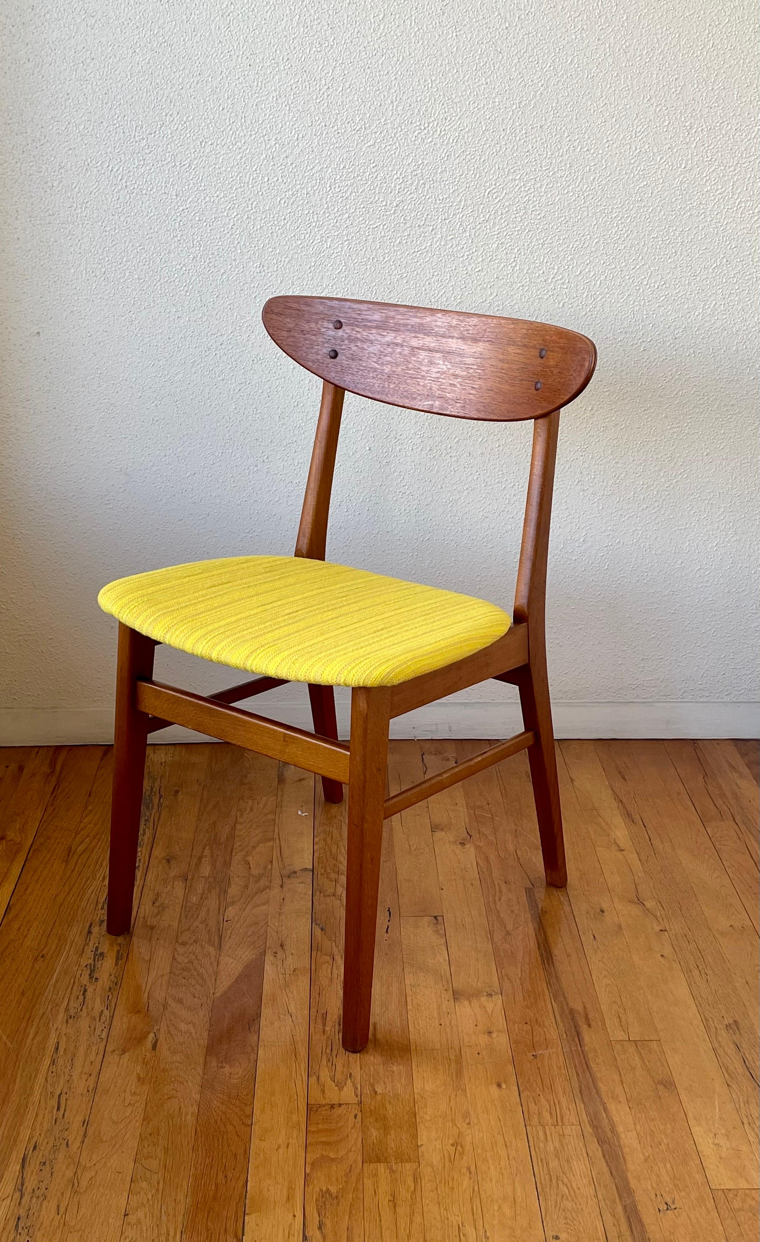 Beautiful pair of Danish chairs with solid maple frames and molder curved backrest in teak, circa 1950s we have refinished the chairs recover the seats with original vintage Danish fabric, reglue the joints these chairs are solid and sturdy and