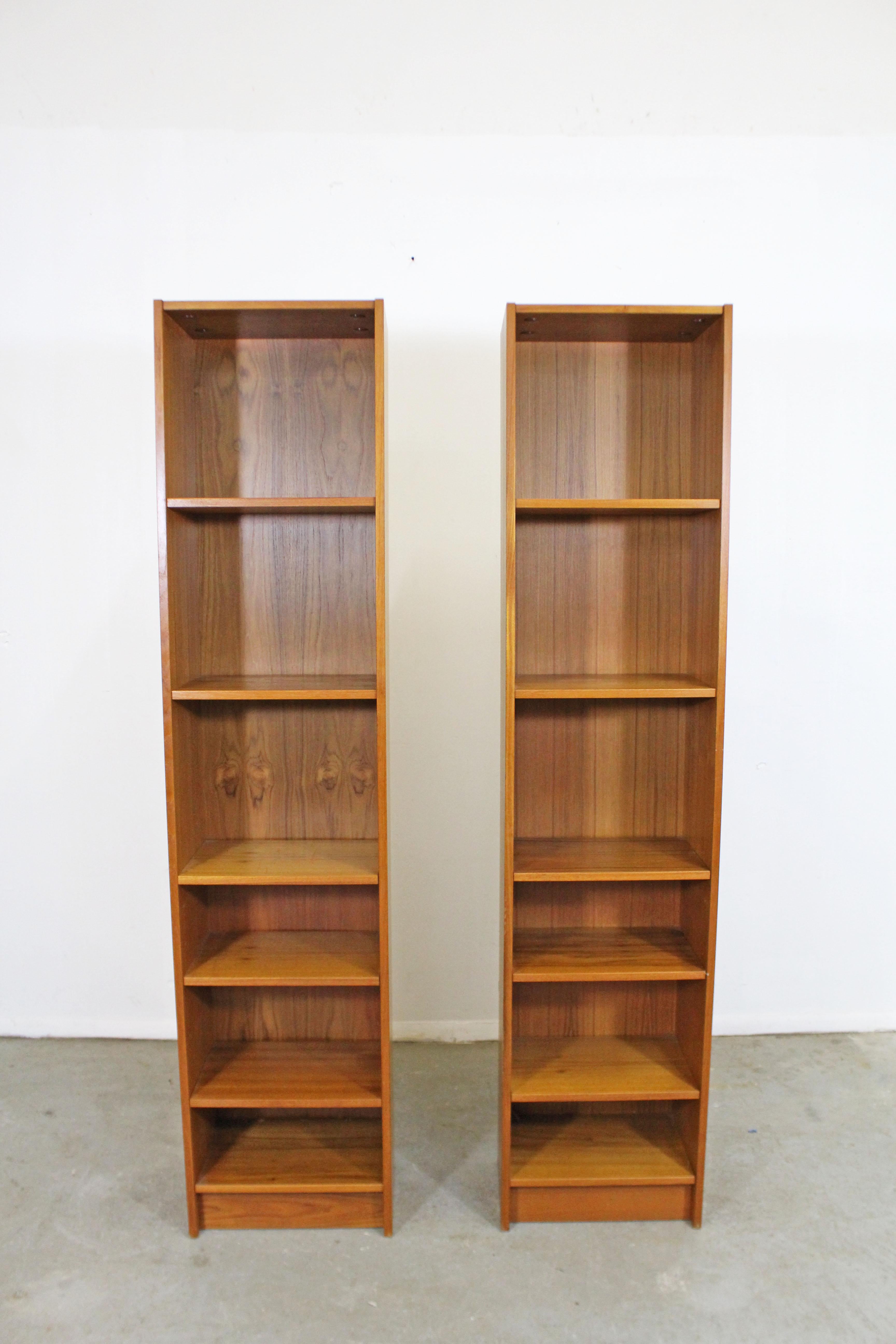 Offered is a Danish modern teak bookcase by Domino Mobler. This teak bookcase includes five adjustable shelves. In good vintage condition, has some surface scratches, wear, and small chips on bottom corners (see photos). It is marked on the back.
