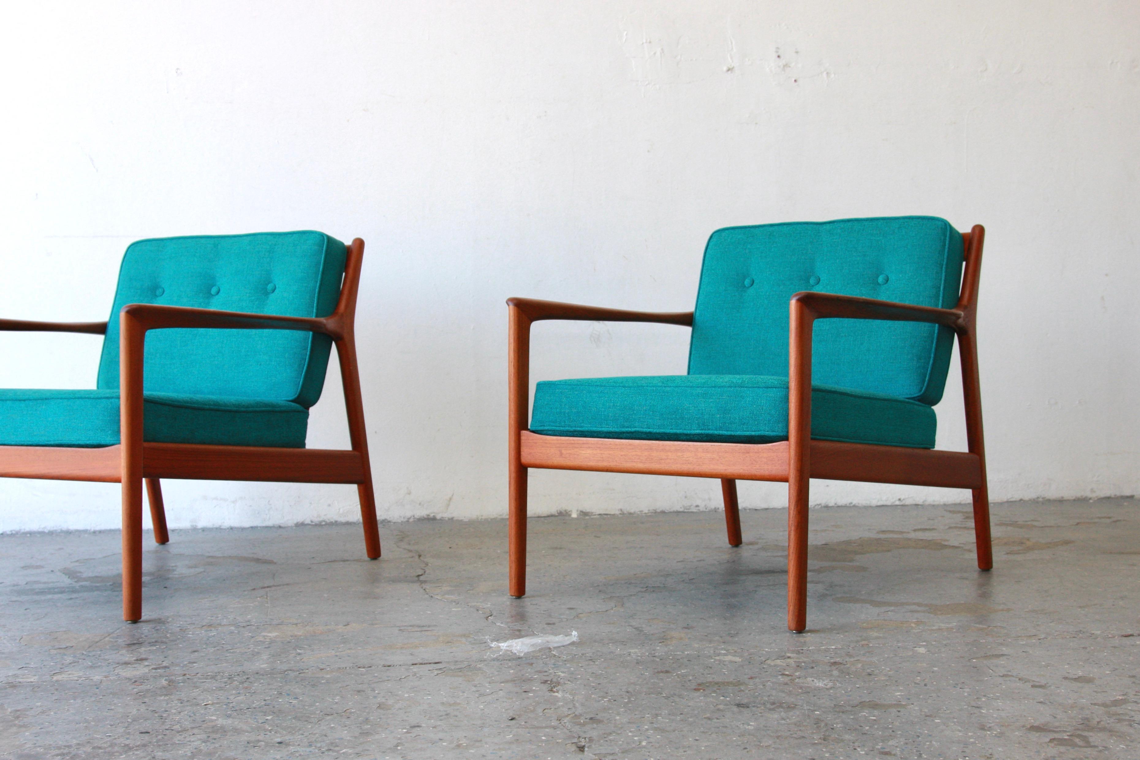 Pair of Danish Modern Dux  USA75 Chairs designed by Folke Ohlsson Sweden 
Pair of USA 75 model armchairs in teak by Swedish designer Folke Ohlsson. The design of these armchairs is distinguished by a very taut line of the armrests and the rear legs