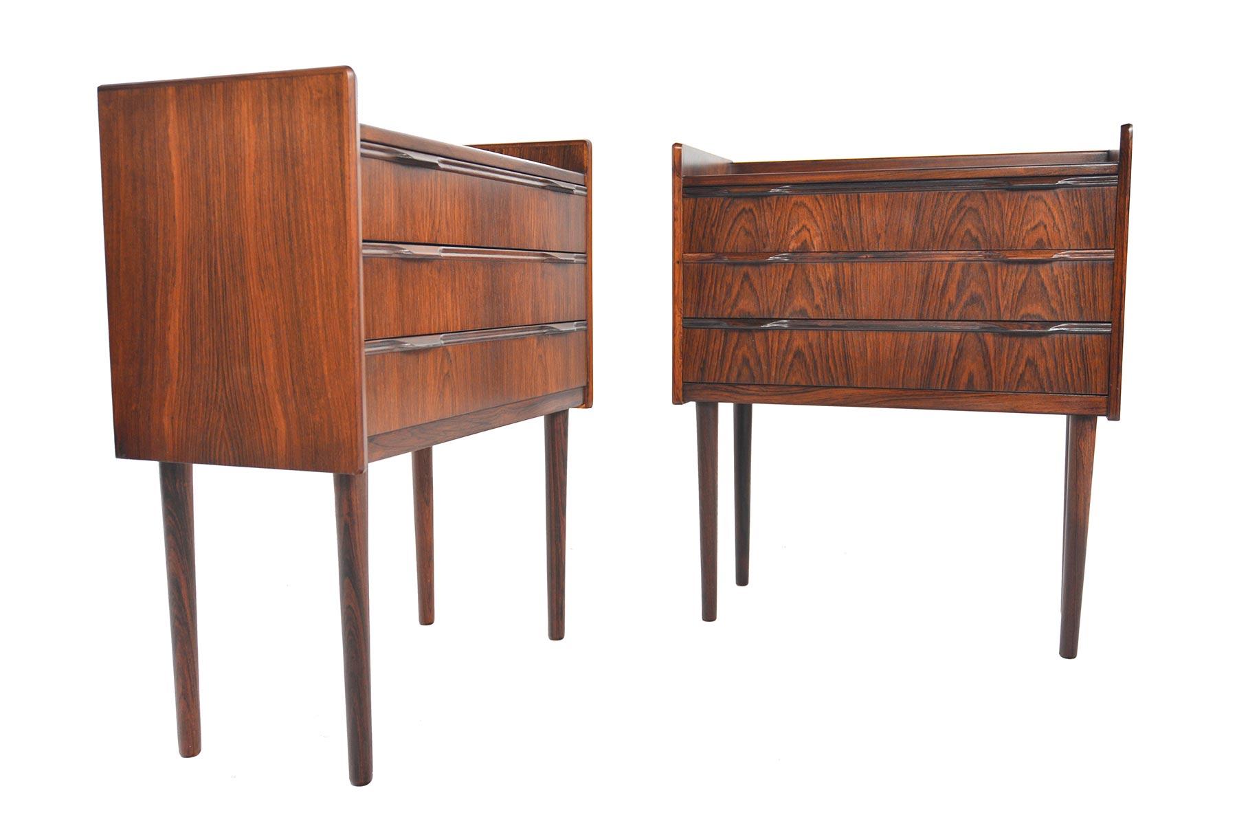 This rare set of Danish modern Knud Nielsen nightstands are crafted in rich Brazilian rosewood. Edged bookcase tops and routed drawer pulls offer crisp detailing. Pieces stand on tall rosewood spindle legs. In excellent original condition.

  