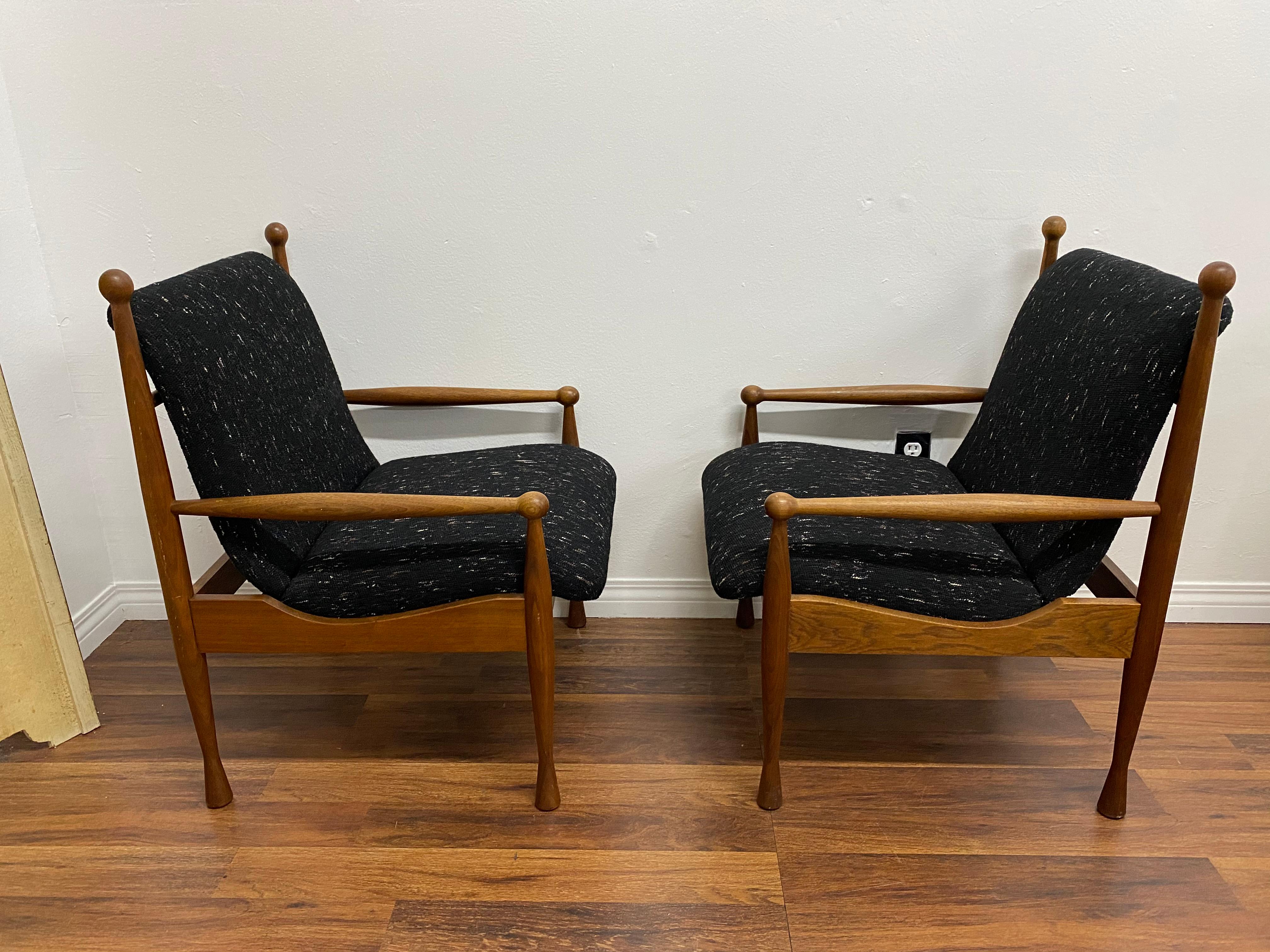 A pair of Danish teak armchairs, circa 1960s.Features a tweed upholstery. Great lines with excellent craftsmanship.