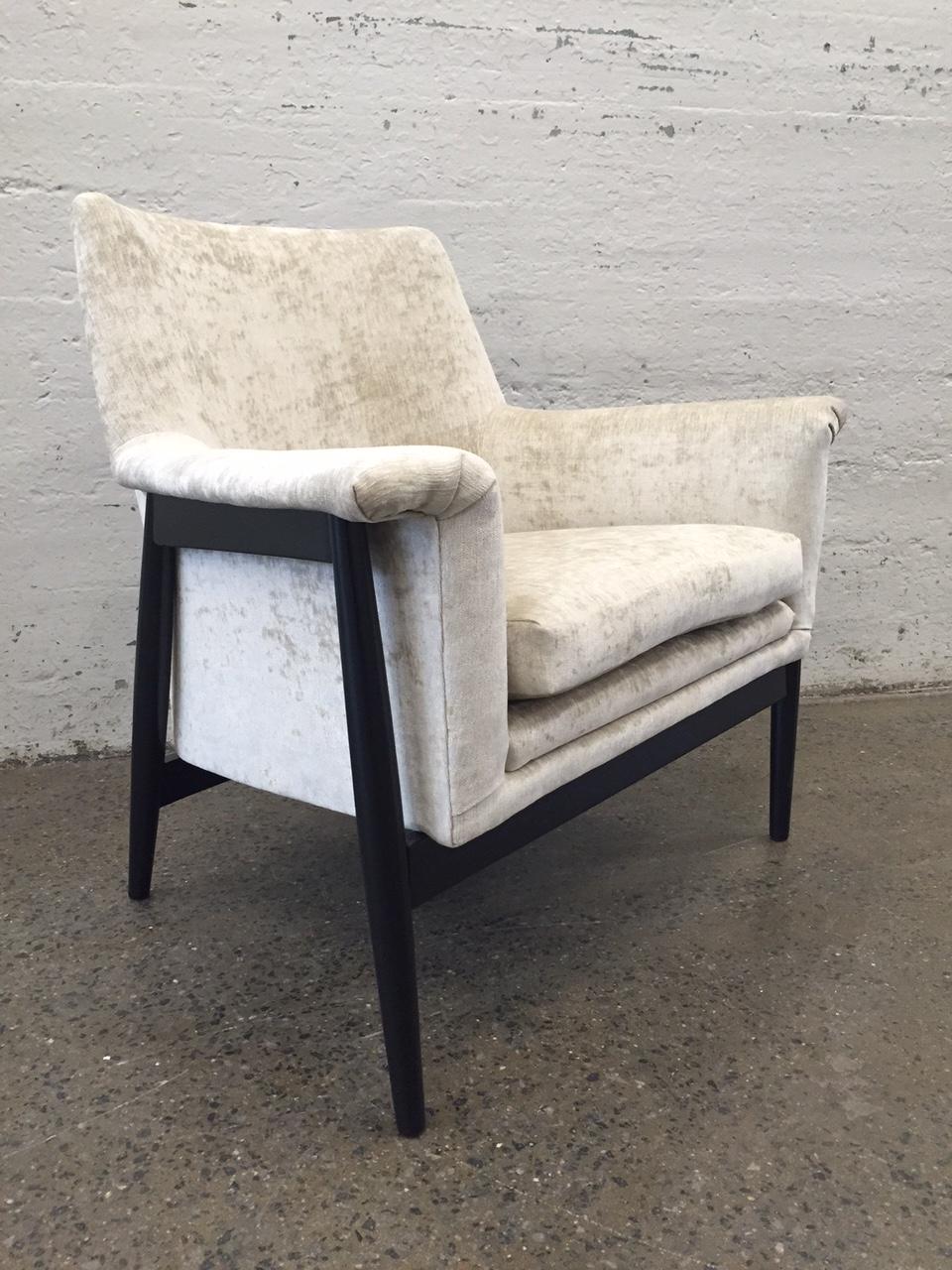 Pair of Danish modern lounge chairs. Chairs have a black lacquered frame and are newly upholstered in velvet. Ib Kofod Larsen style. Chairs have been refinished and reupholstered. Mid Century Modern.