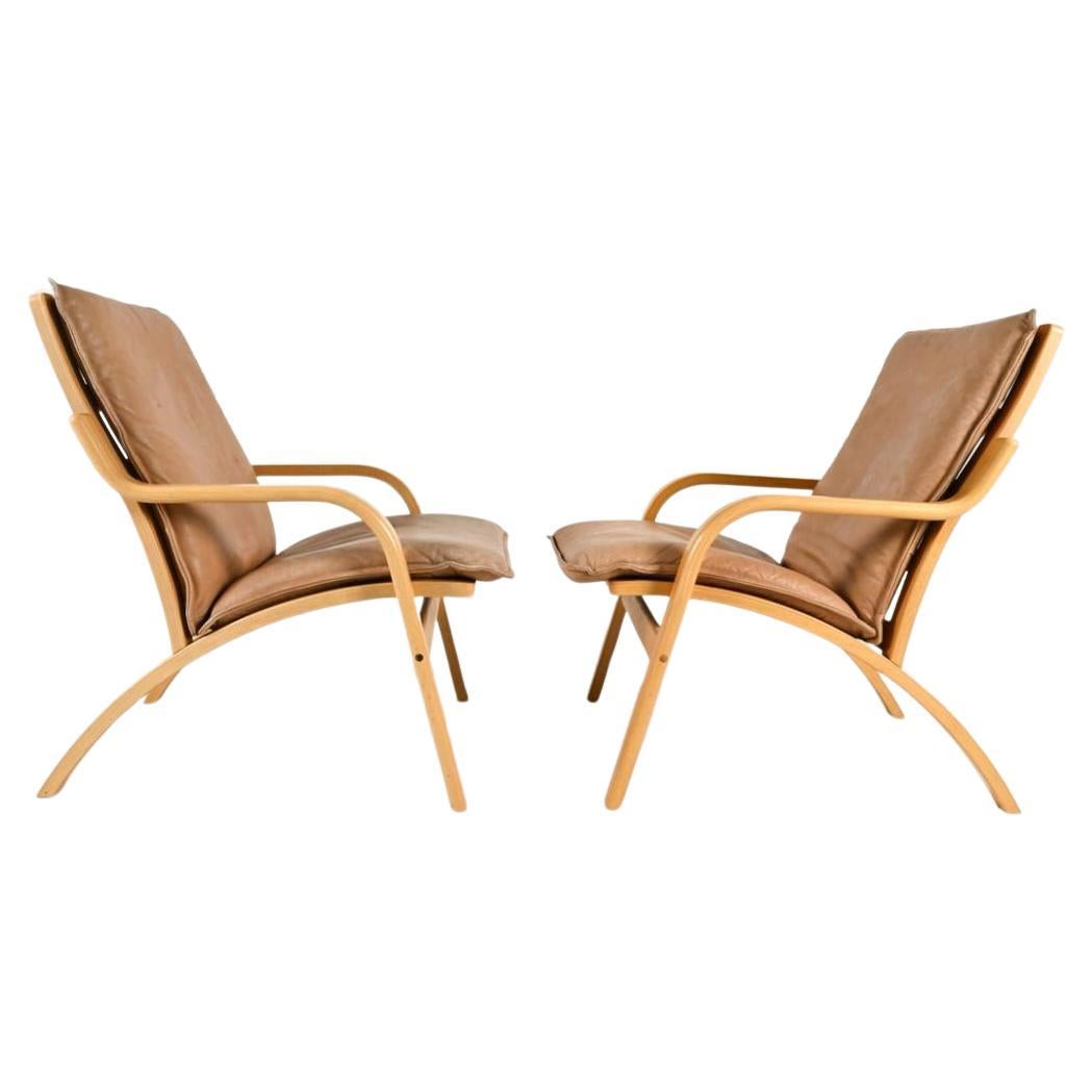 Pair of Danish Modern lounge chairs in bent beech wood and tan leather by Stouby In Good Condition For Sale In BROOKLYN, NY