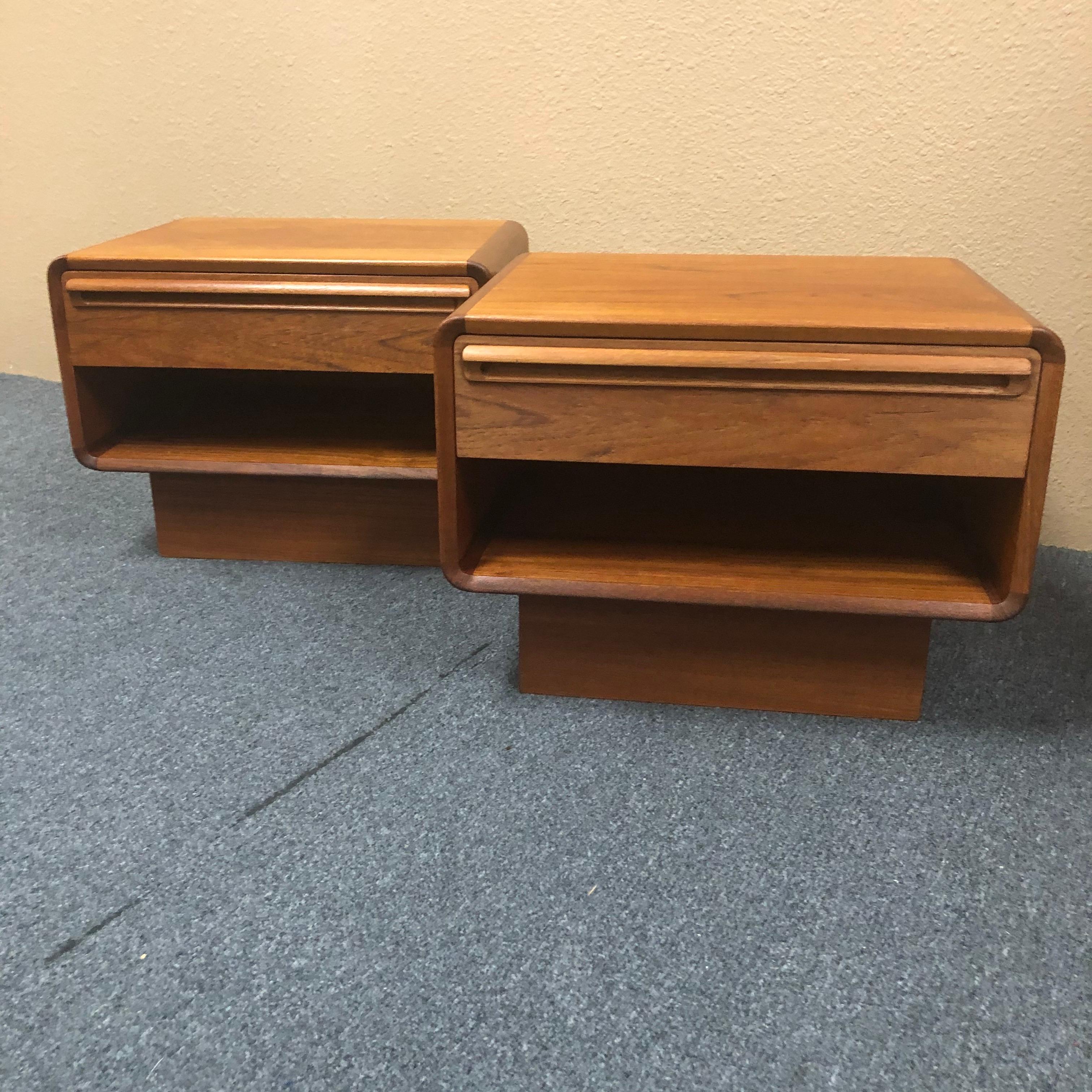 Sleek pair of Danish modern low profile one-drawer teak nightstands, circa 1960s. The pair has been professionally refinished and measure 20.5