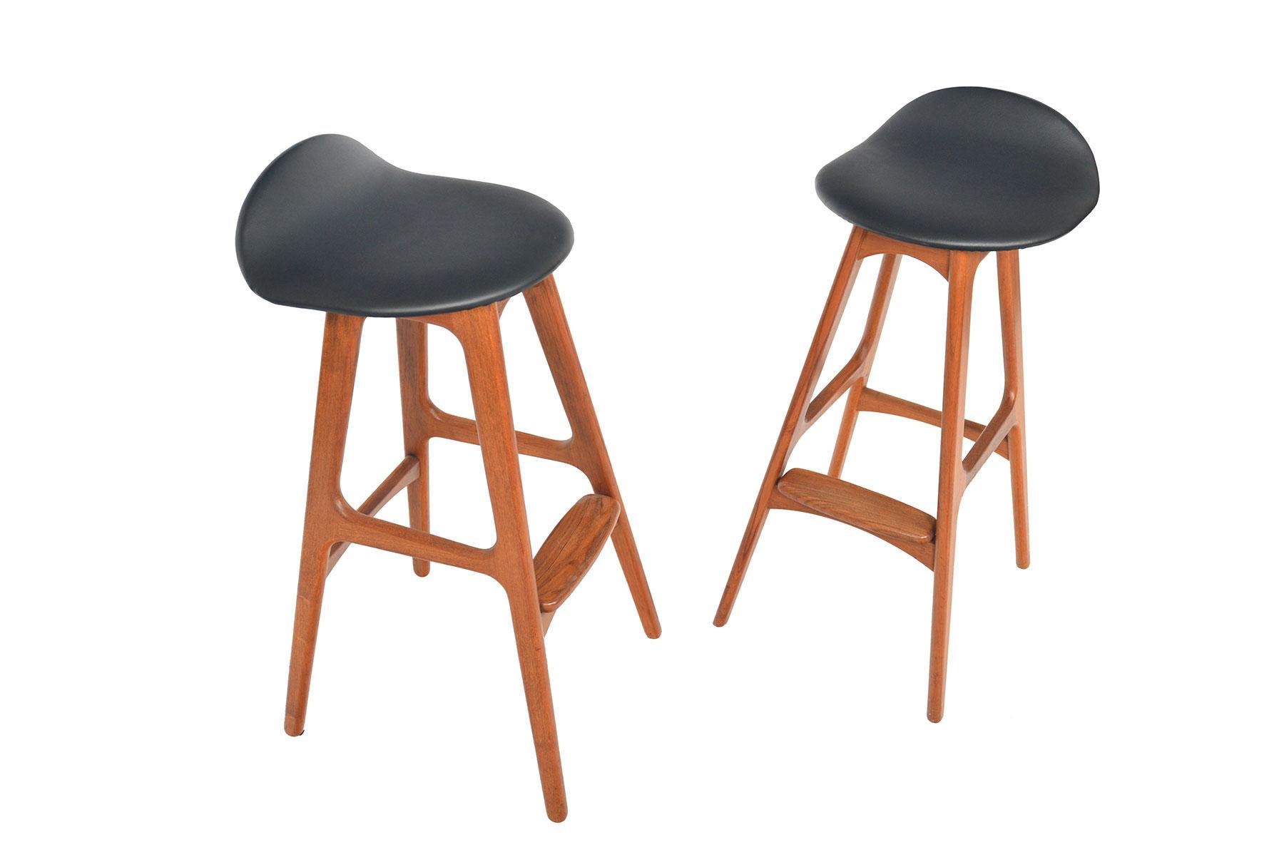 This phenomenal pair of Danish modern mid century barstools was designed by Erik Buch in the 1960s! This vintage pair is crafted in teak. The cushion is newly covered in black vinyl. In excellent original condition.

