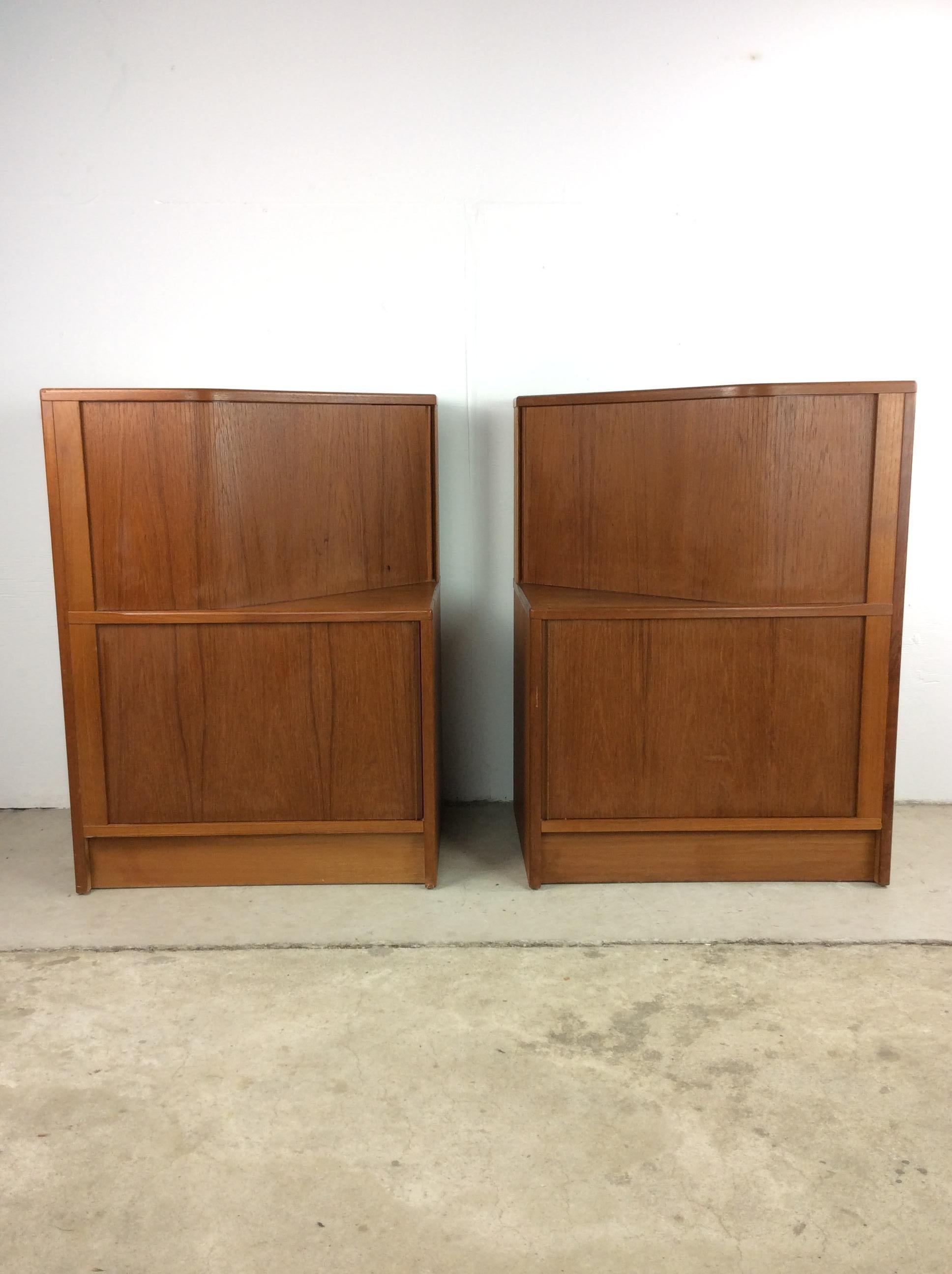This pair of danish modern nightstands feature pressed wood construction, original teak finish, open storage up top with shelving down below, and each compartment has its own tambour door.

Complimentary large dresser / armoire available separately.