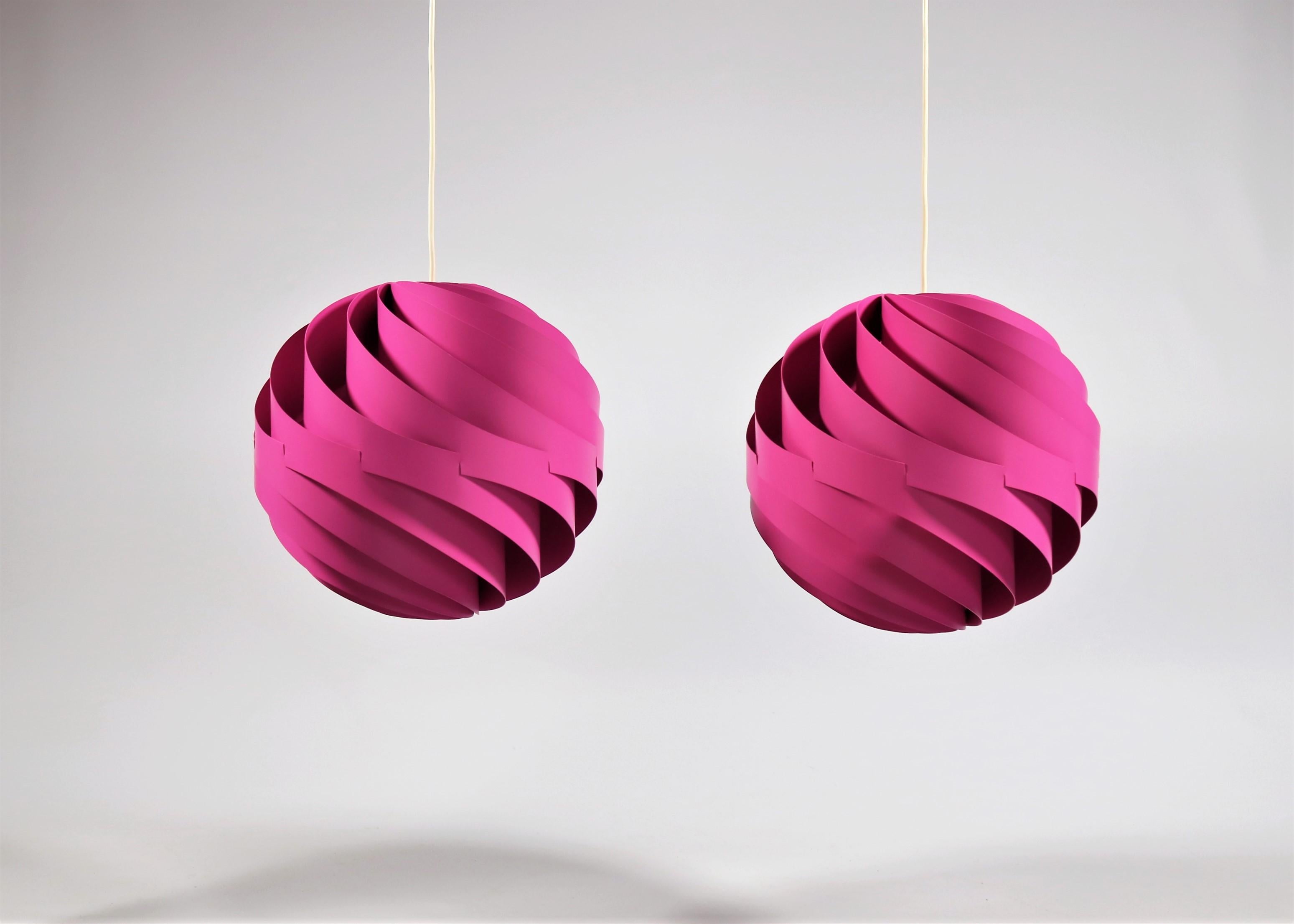 This amazing pair of pink/magenta Turbo 1 pendants was designed by Danish architect Louis Weisdorf in 1965 and produced by Lyfa from 1967 and until the early 1970s.

They are an extremely rare find in this color and amazingly enough this pair has
