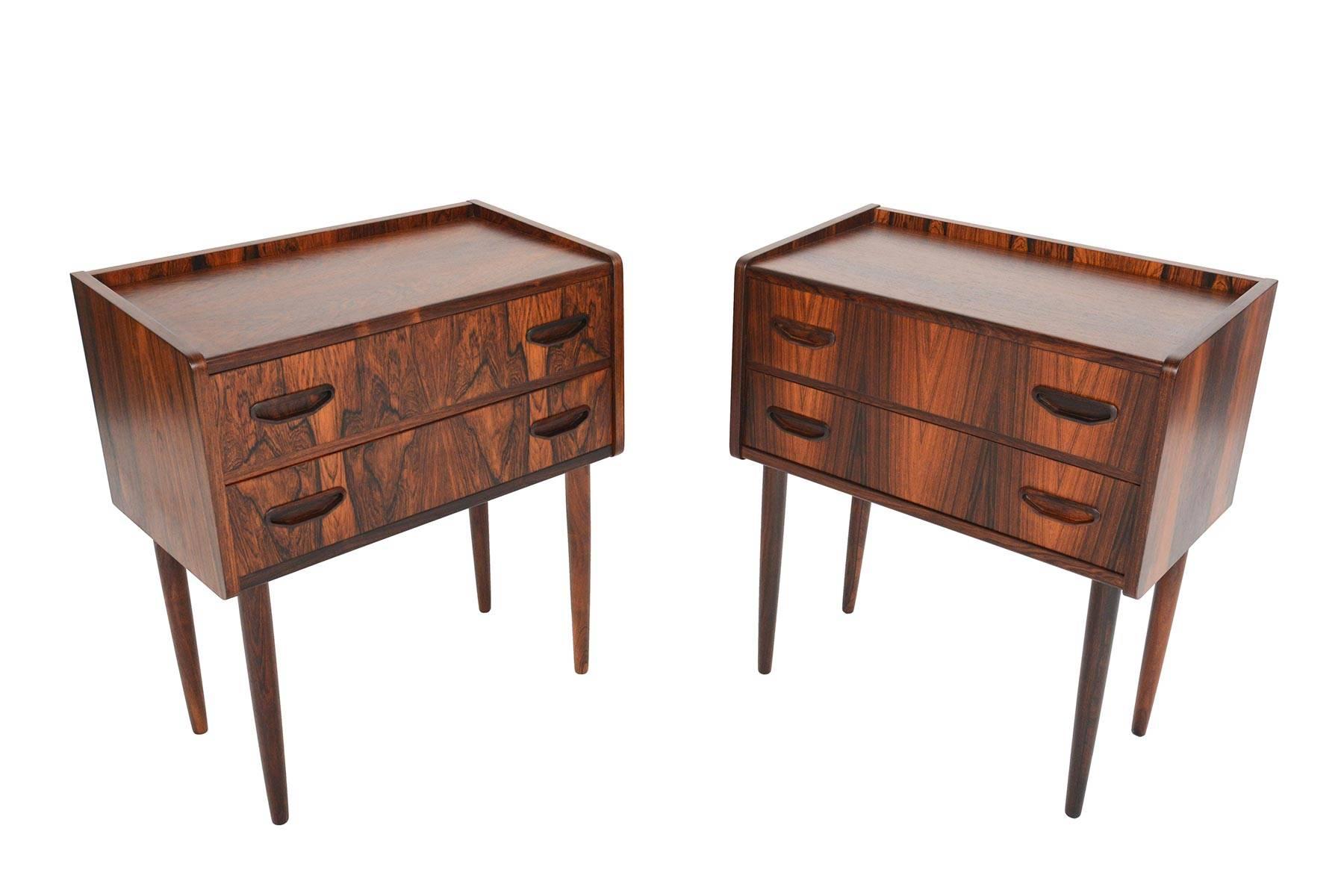 This pair of rare Danish modern midcentury two-drawer nightstands will make a statement in any modern home. Constructed from Brazilian rosewood with unique and distinctive grain, this pair features beautiful craftsmanship throughout. The drawers are