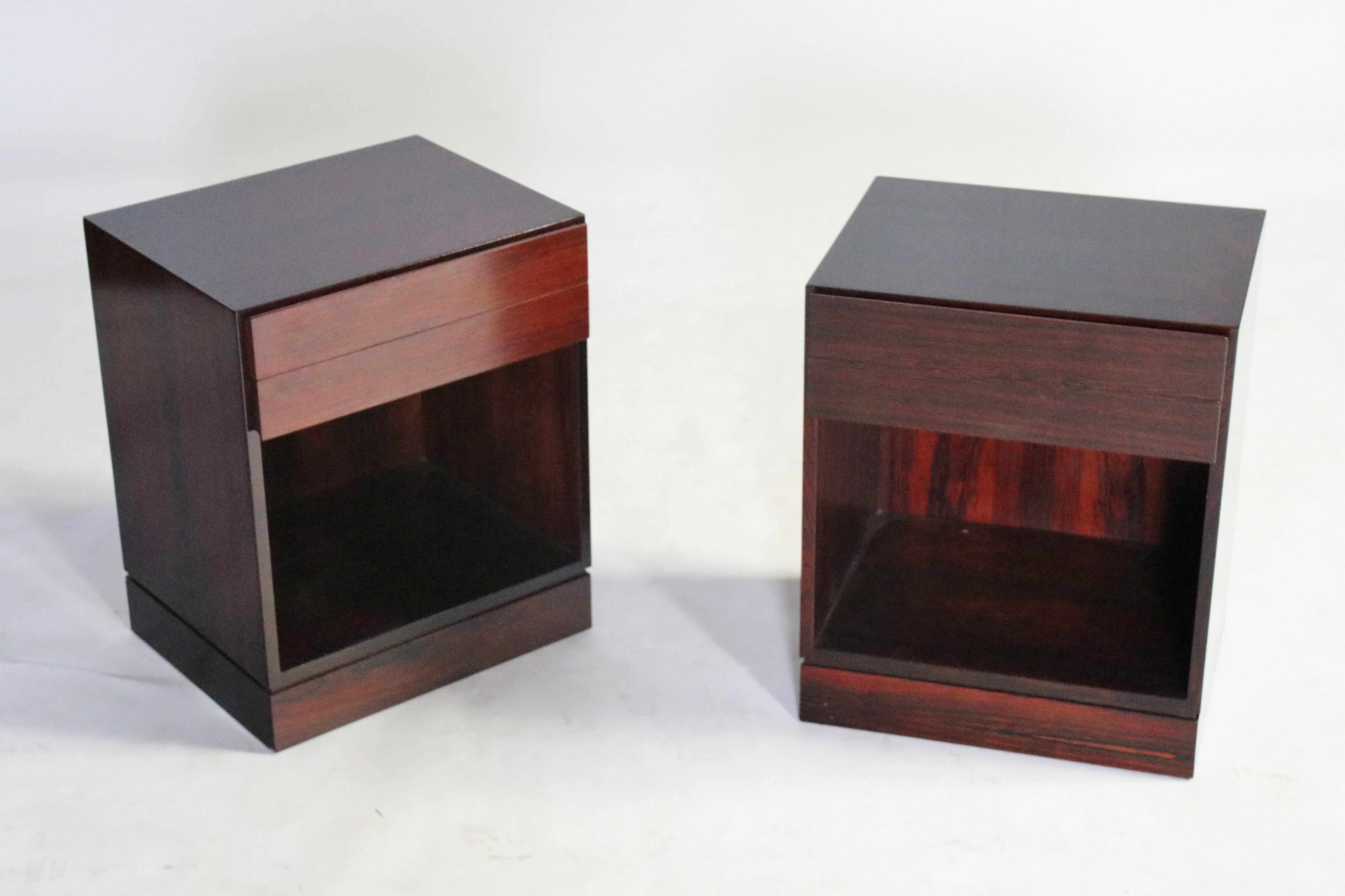 Pair of midcentury Danish modern rosewood nightstands each with two shallow pull-out drawers and an open storage cabinet, stamped, made in Denmark.