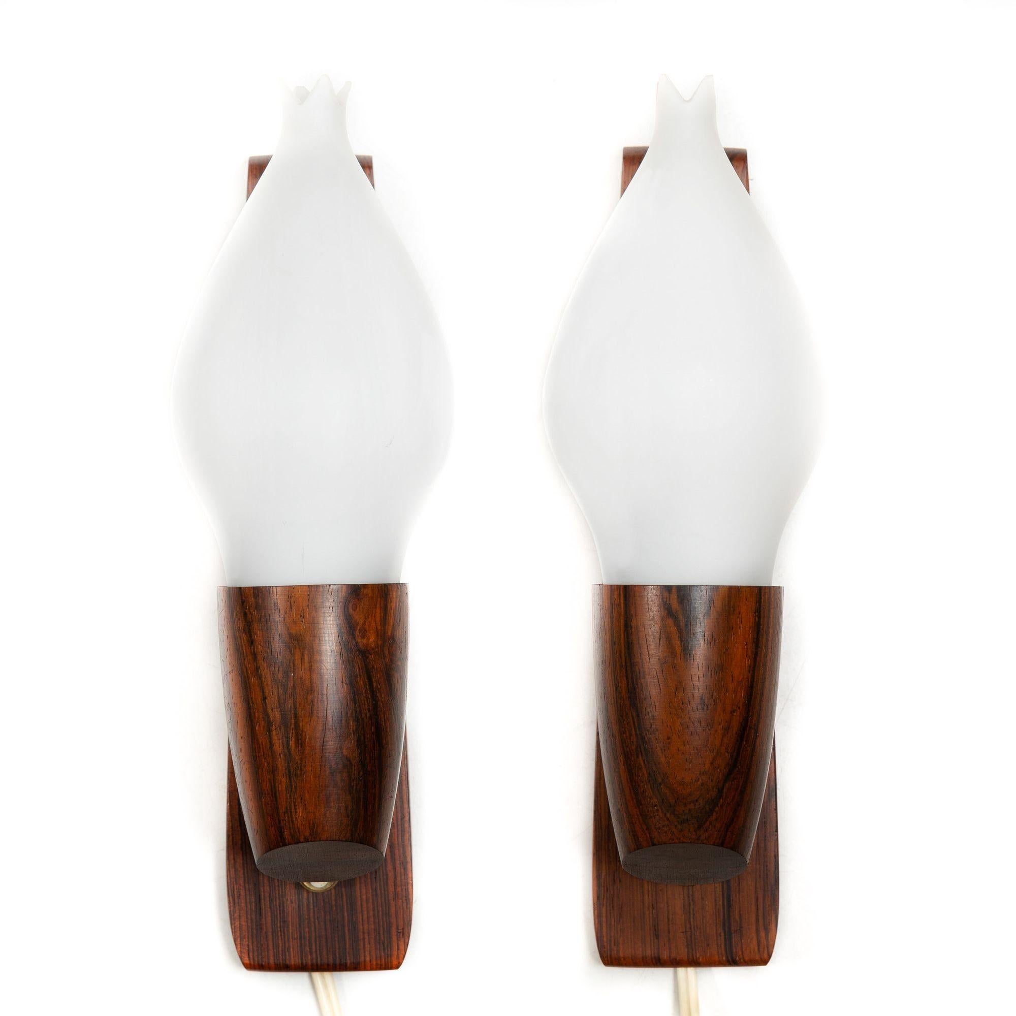 PAIR OF DANISH MODERN ROSEWOOD AND FROSTED-GLASS WALL SCONCES
Designed by Vitrika, Denmark circa 1970s
Item # 311VNK02P-2

A perfect representation of the elegance of Danish design, this sleek pair of sculpted rosewood wall sconces were designed by