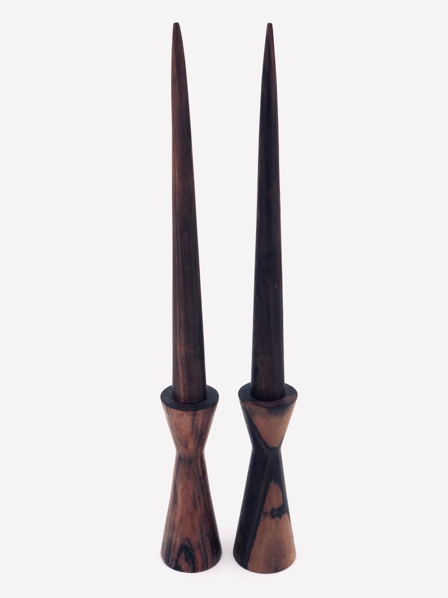 Beautiful pair of solid rosewood hand-turned candle sticks, circa 1970s nice condition with fake solid rosewood candles nice weight and condition.