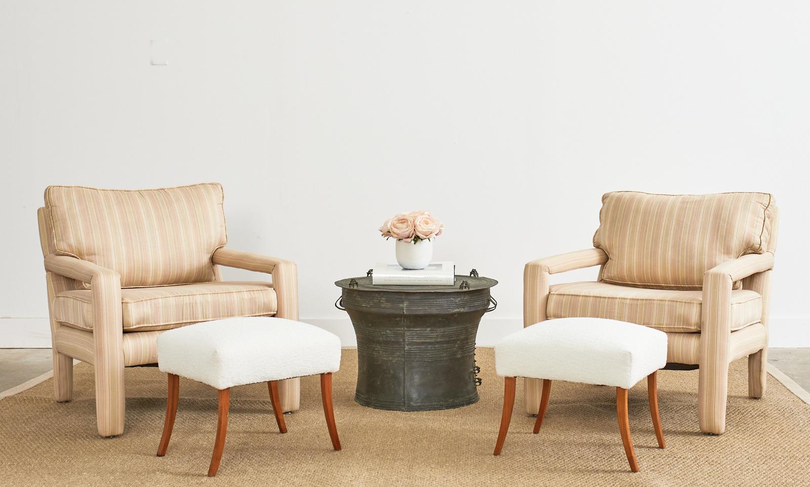 Stunning pair of Scandanavian or Danish modern style footstools featuring a white boucle upholstery. The footstools or footrests feature a wooden frame supported by splayed saber legs giving the stools a whimsical look. Beautifully crafted with good
