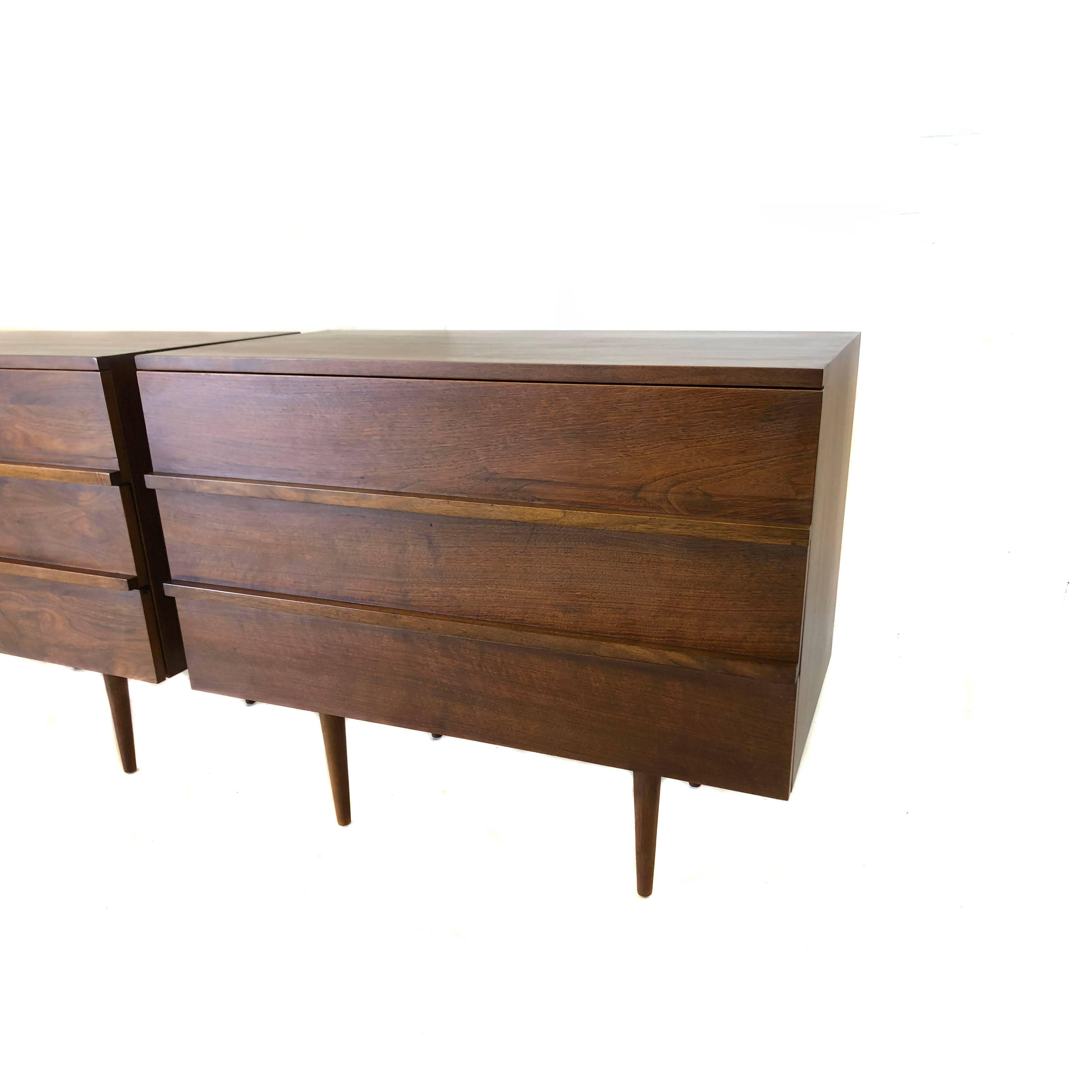 A lovely pair of dressers by Mel Smilow produced in the 1950s. Solid walnut with three drawers. In very good condition with age appropriate wear, some minor scratching. One dresser has slightly warped bottom causing lower most drawer to open with